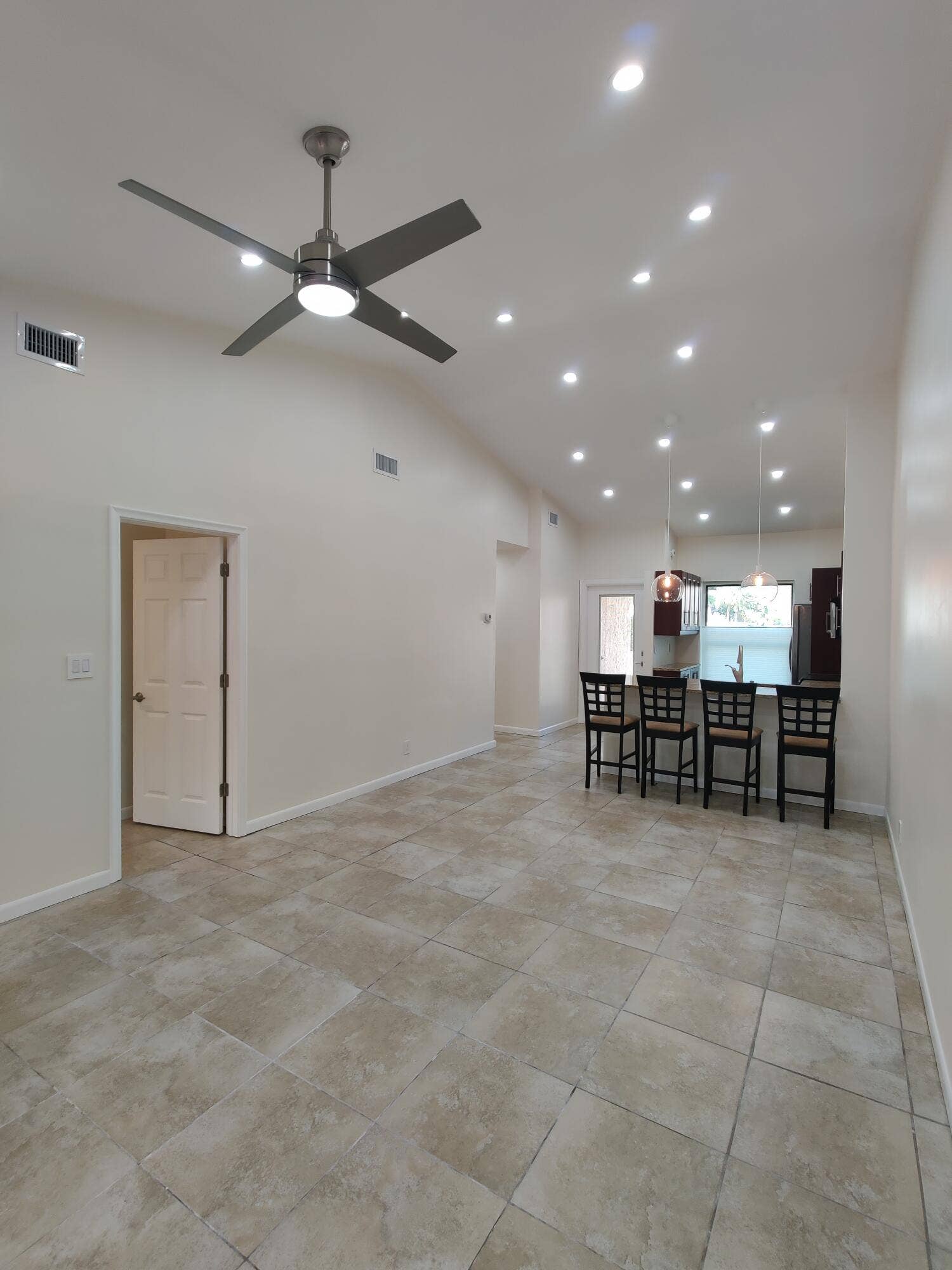 2700 S OAKLAND FOREST Drive, #603, Oakland Park, FL 33309 Vaulted ceilings featuring recessed lighting, a brushed-nickel ceiling fan, and large-format neutral tile flooring
