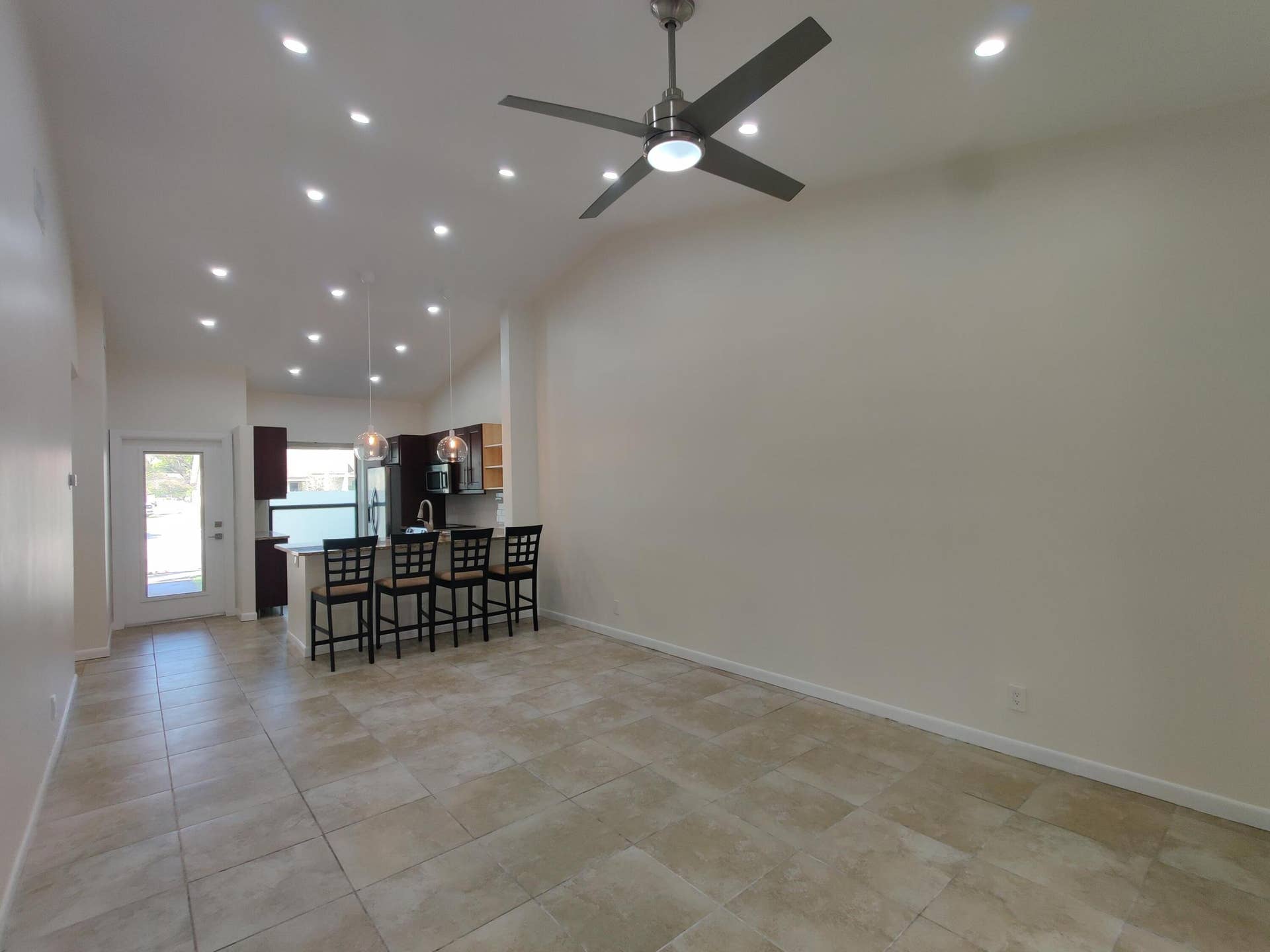 2700 S OAKLAND FOREST Drive, #603, Oakland Park, FL 33309 Vaulted ceilings featuring recessed lighting, a modern ceiling fan, tile flooring, and a kitchen island with dual pendant lighting