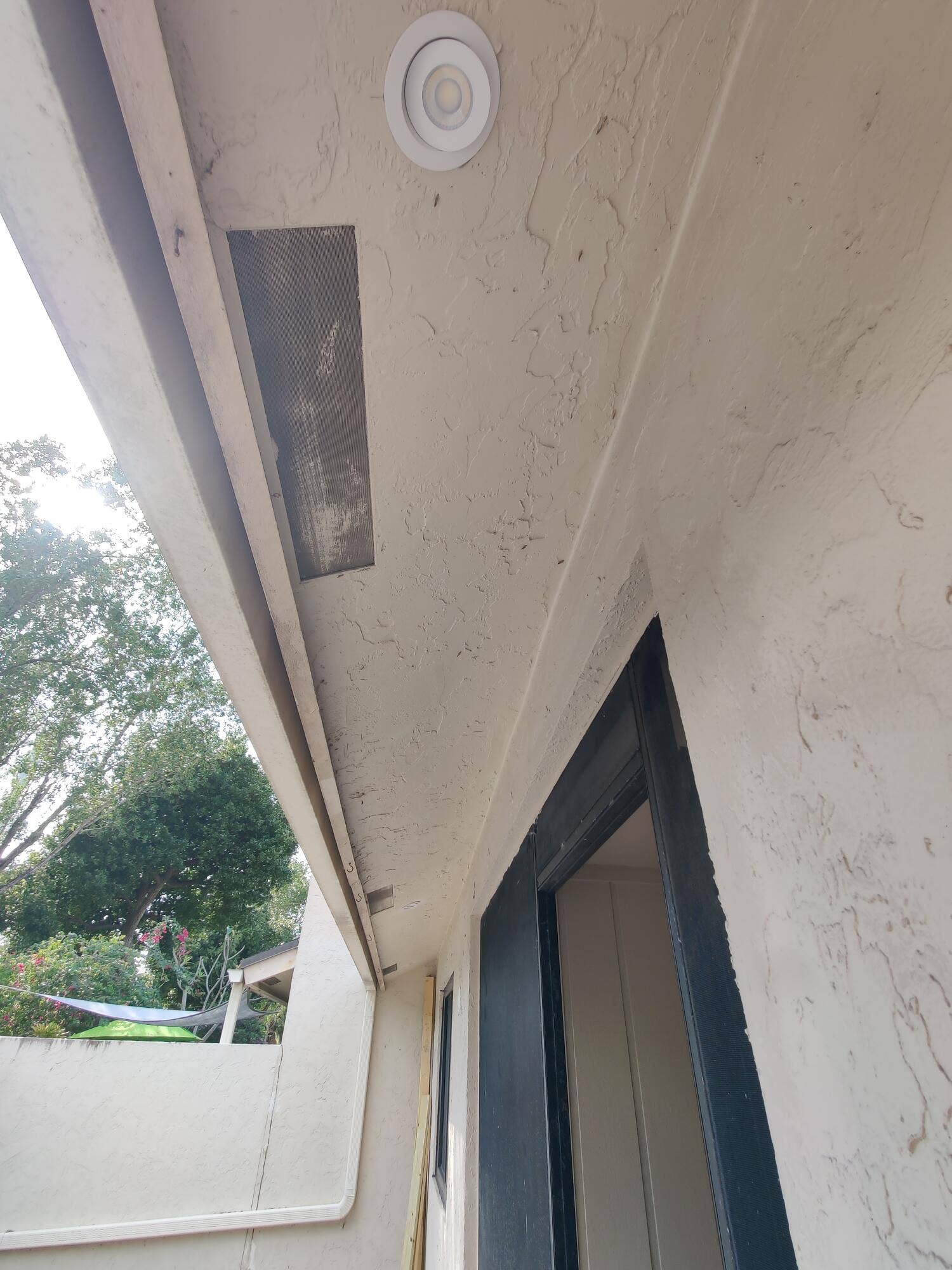 2700 S OAKLAND FOREST Drive, #603, Oakland Park, FL 33309 Exterior covered area featuring a textured stucco finish, recessed lighting, and a dark-toned door frame