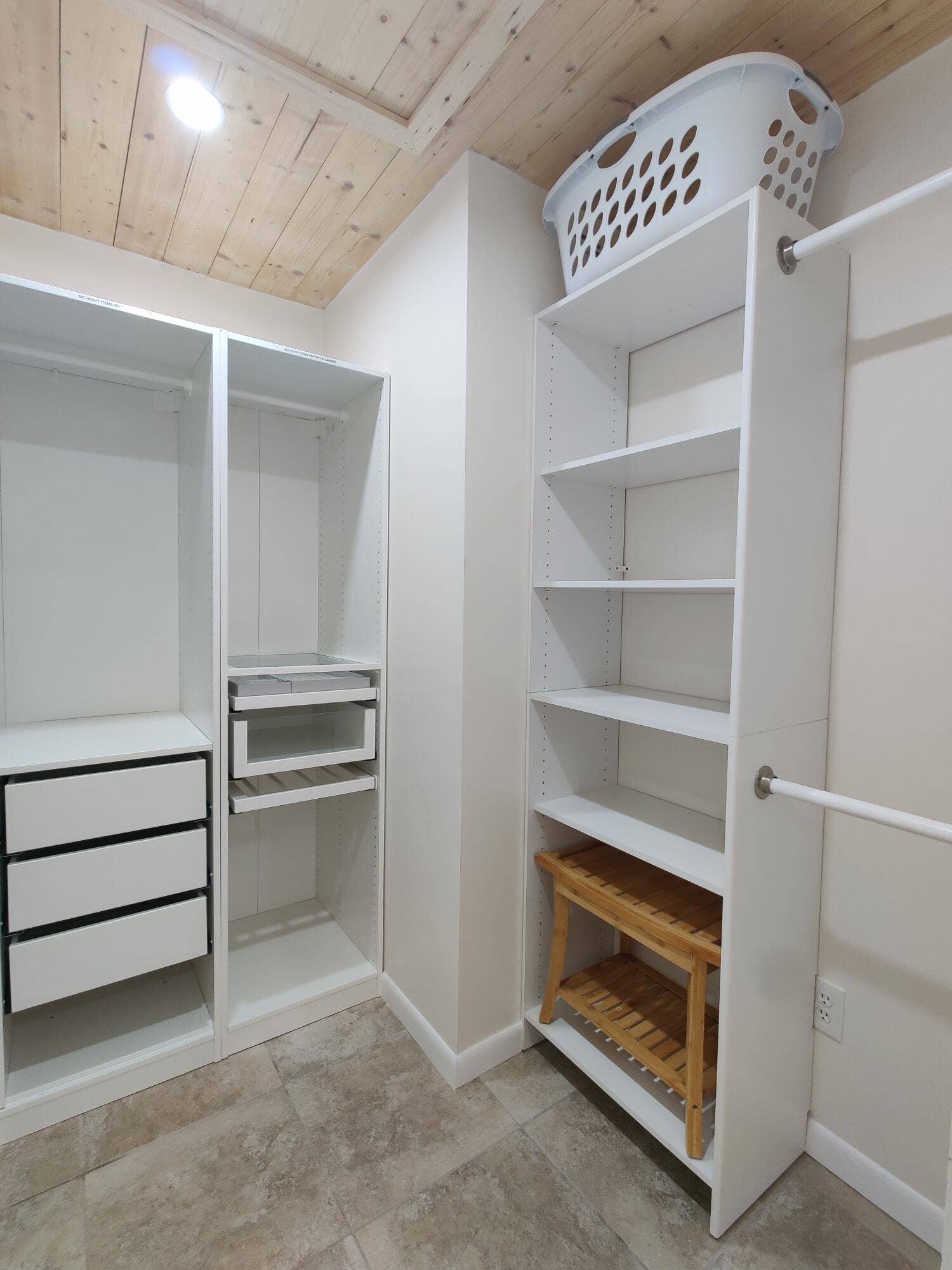 2700 S OAKLAND FOREST Drive, #603, Oakland Park, FL 33309 Walk-in closet featuring white built-in shelving, integrated dresser drawers, dual hanging rods, and wood-plank ceiling finish with tile flooring
