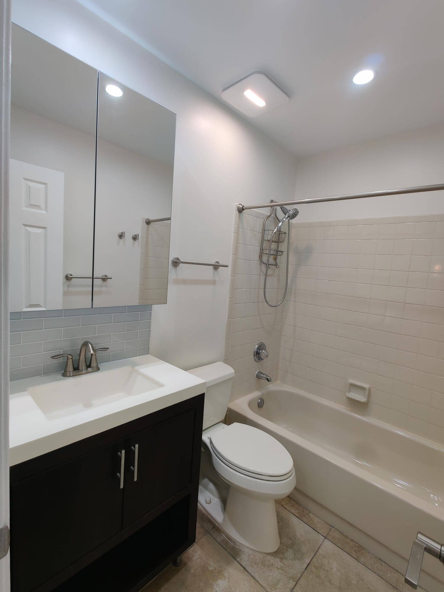 2700 S OAKLAND FOREST Drive, #603, Oakland Park, FL 33309 Bathroom featuring a vanity with a white countertop and rectangular basin, a mirrored medicine cabinet, a tiled tub-shower combination, and recessed lighting