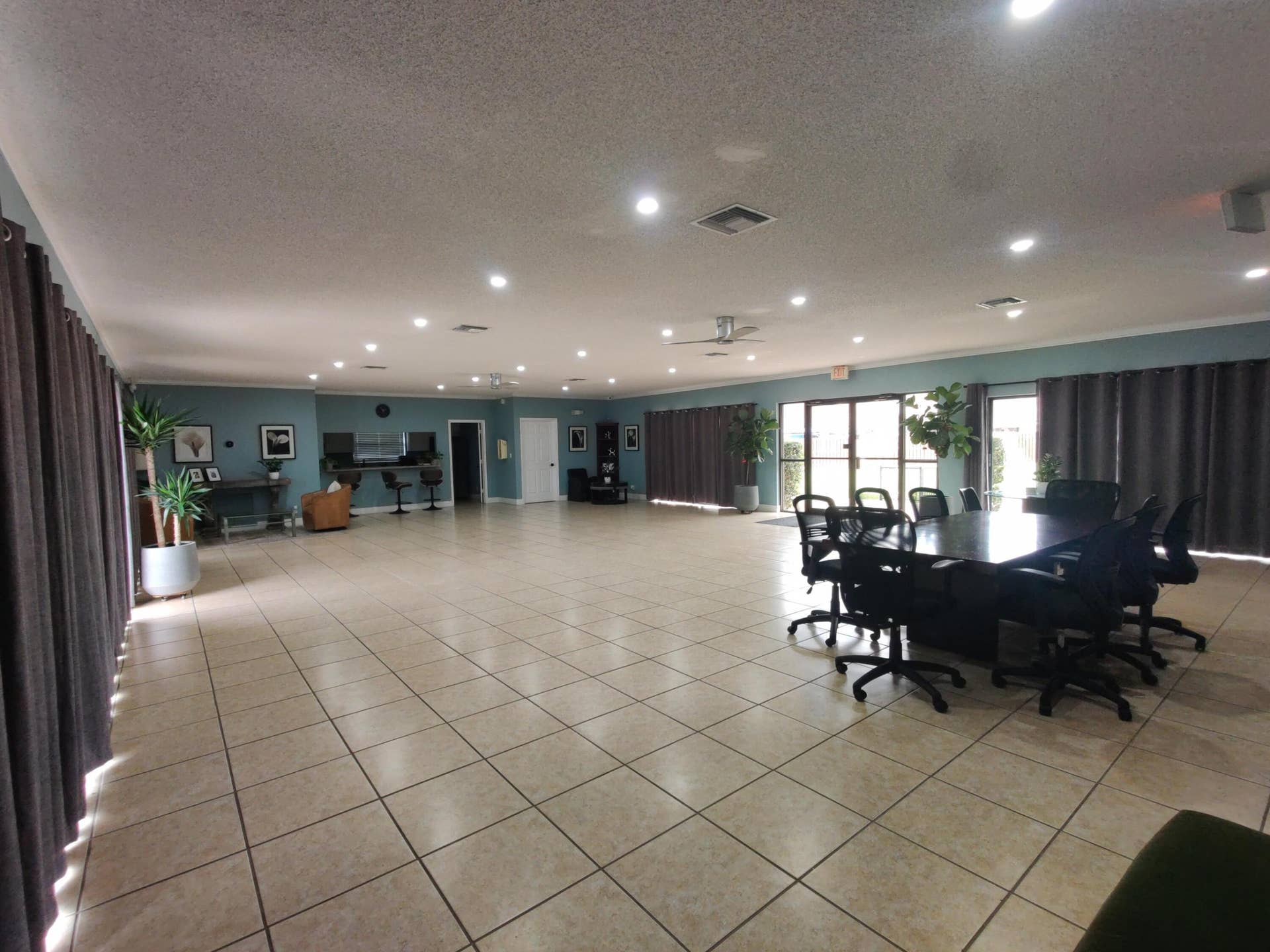 2700 S OAKLAND FOREST Drive, #603, Oakland Park, FL 33309 Expansive open-concept space featuring tile flooring, recessed lighting, a built-in wet bar, and multiple sets of glass exterior doors