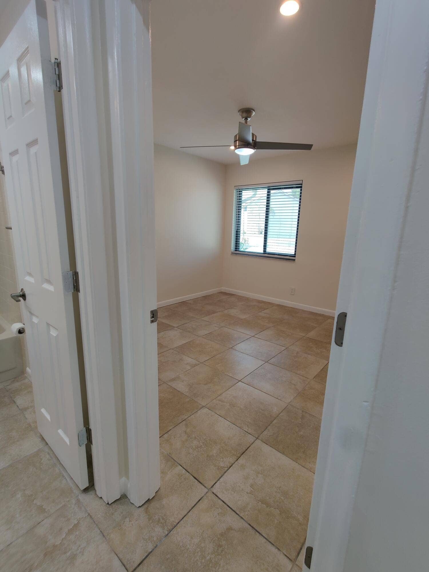 2700 S OAKLAND FOREST Drive, #603, Oakland Park, FL 33309 Room featuring square-tile flooring, recessed ceiling lighting, a multi-blade ceiling fan, and a single-pane window