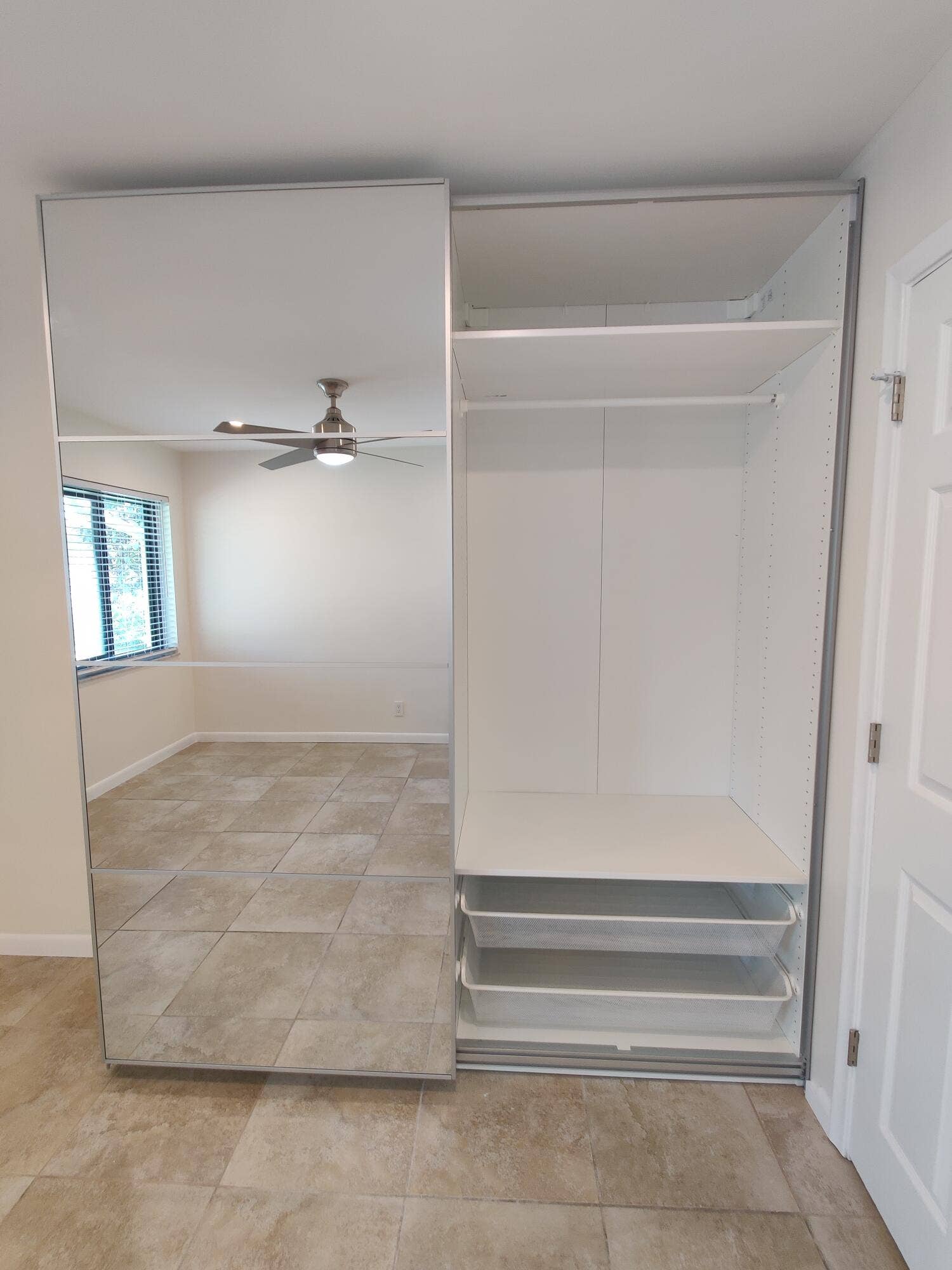 2700 S OAKLAND FOREST Drive, #603, Oakland Park, FL 33309 Built-in floor-to-ceiling wardrobe featuring mirrored sliding doors, interior shelving, a hanging rod, and two pull-out drawers