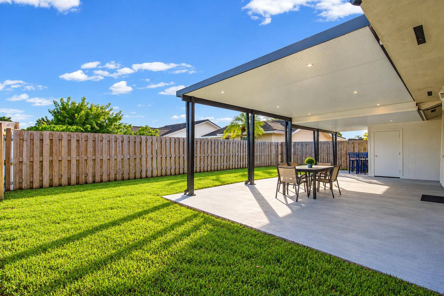 Modern Covered Patio and Lush Backyard