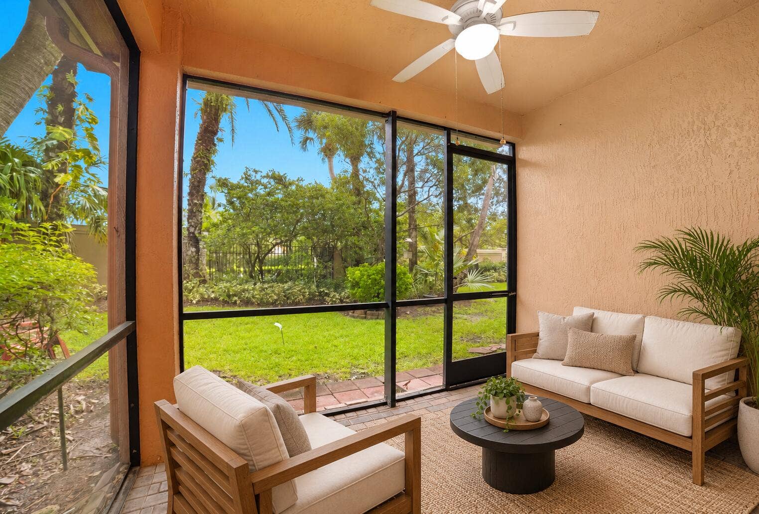 13011 Riverwalk Circle N, Plantation, Plantation, FL 33325 Screened-in lanai featuring a paver floor, textured walls, and a ceiling-mounted fan with integrated lighting