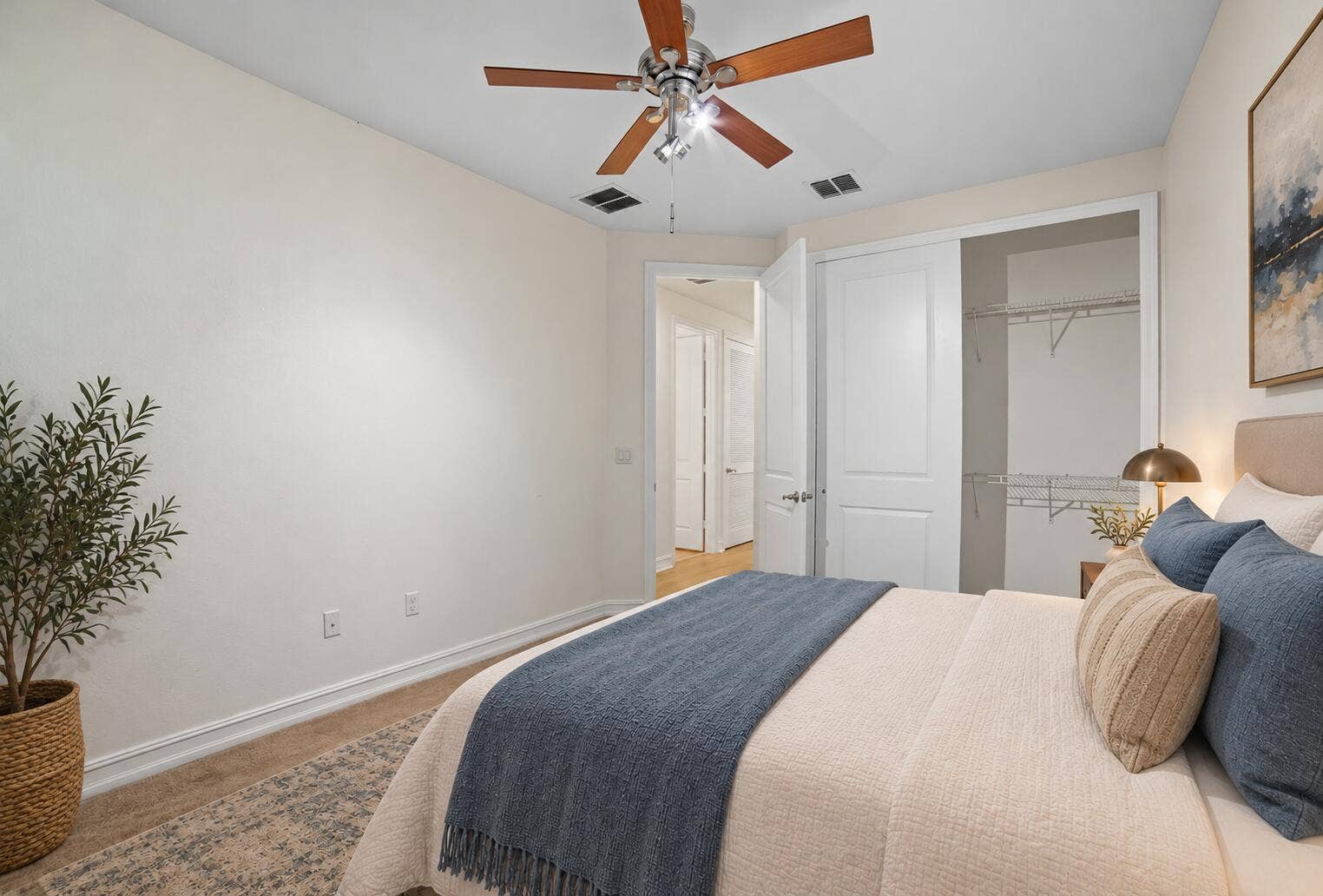 13011 Riverwalk Circle N, Plantation, Plantation, FL 33325 Neutral interior room featuring a ceiling fan with wood-finish blades, a multi-panel interior door, and a built-in closet with wire shelving