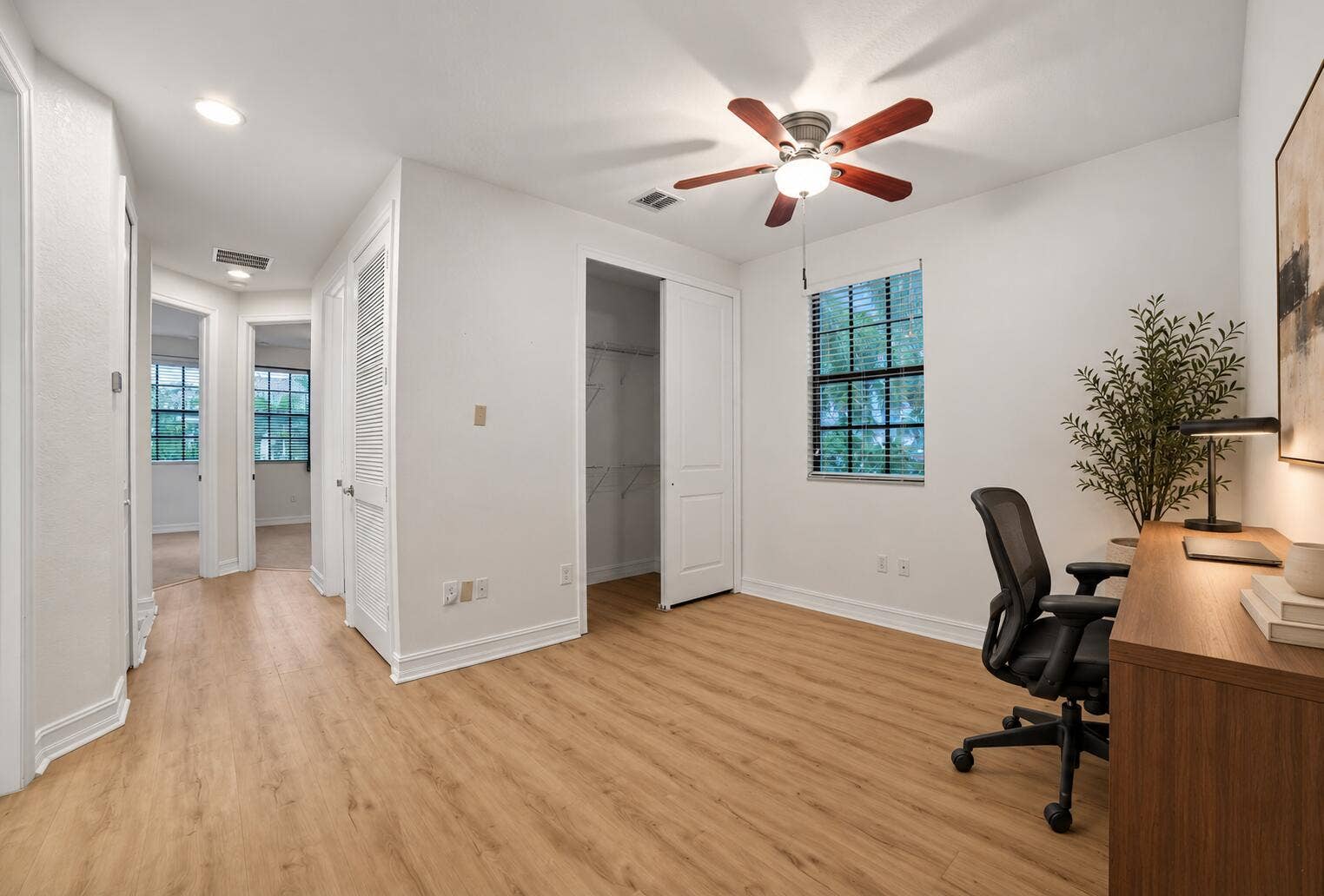 13011 Riverwalk Circle N, Plantation, Plantation, FL 33325 Neutral interior featuring wood-finish flooring, a ceiling fan with integrated lighting, a closet with double doors, and a window with blinds