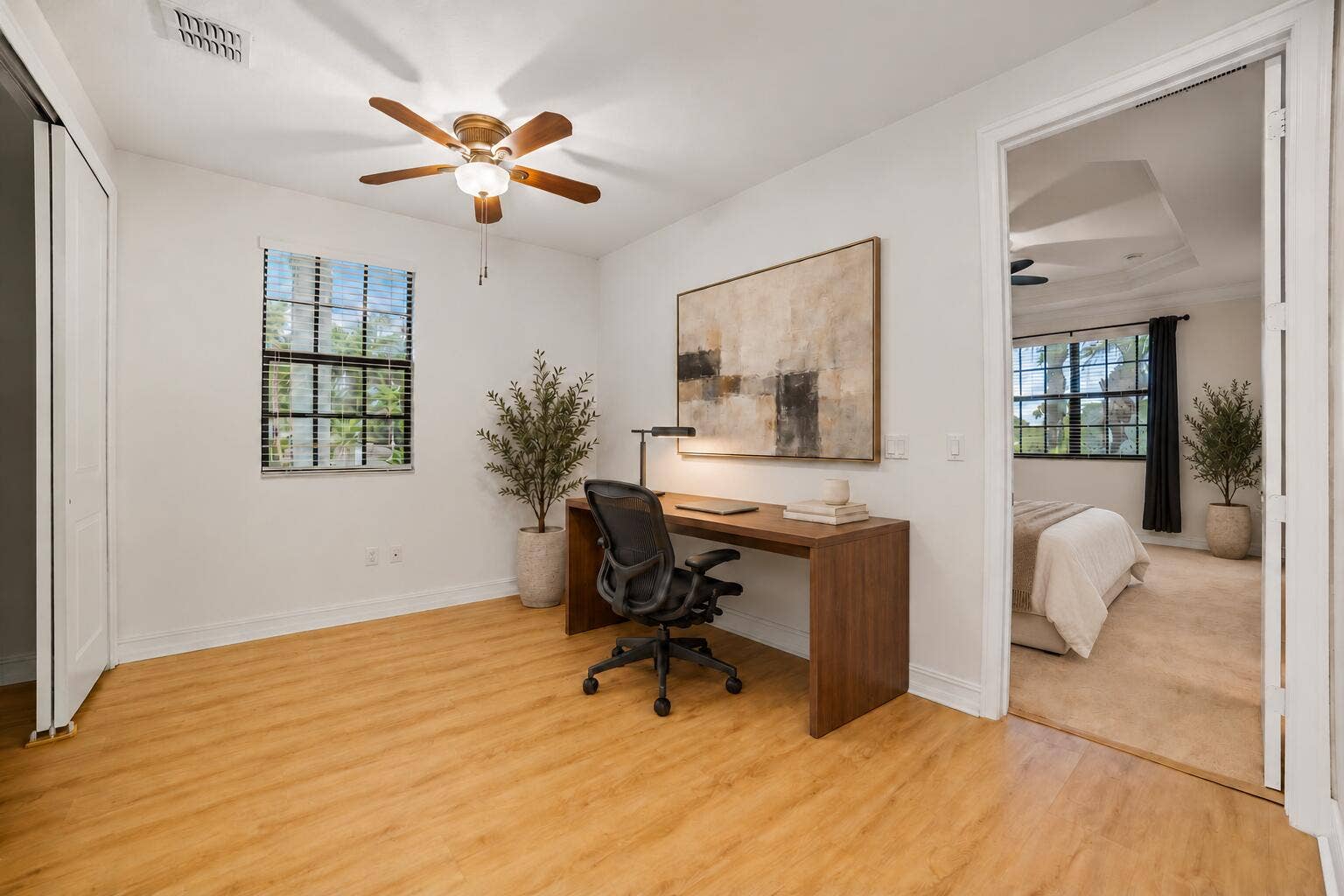 13011 Riverwalk Circle N, Plantation, Plantation, FL 33325 Interior room featuring wood-finish flooring, a multi-blade ceiling fan with integrated lighting, and a single-hung window with a grid pattern