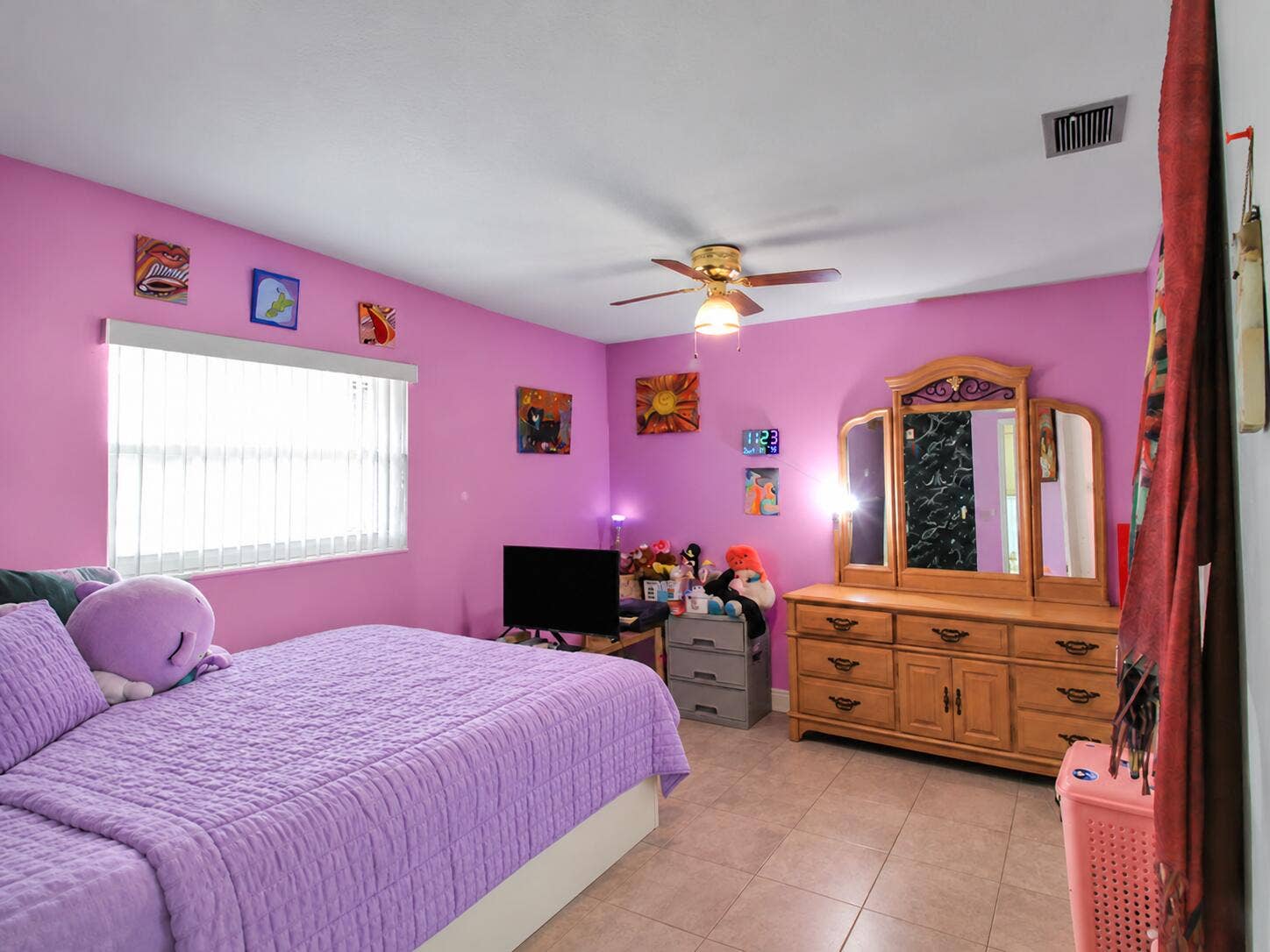 Tidied bedroom with purple bedding
