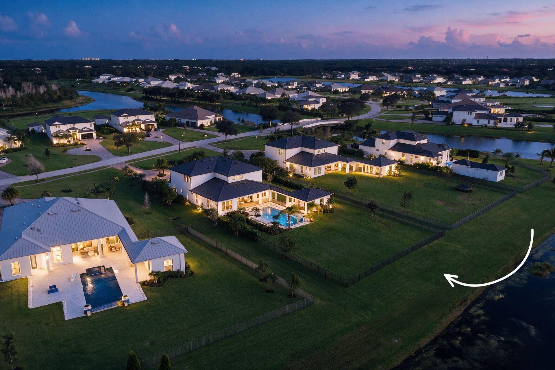 20036 SE BRIDGEWATER Drive, Jupiter, FL 33458 Aerial perspective of a sprawling property featuring a vast manicured lawn, an expansive rear lot boundary, and direct waterfront access