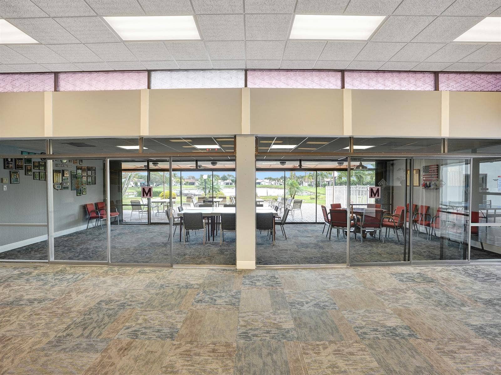 2079 SW 16TH Circle, Deerfield Beach, FL 33442 Large interior space featuring a drop ceiling with recessed lighting, full-height glass sliding wall partitions, clerestory windows, and carpeted flooring