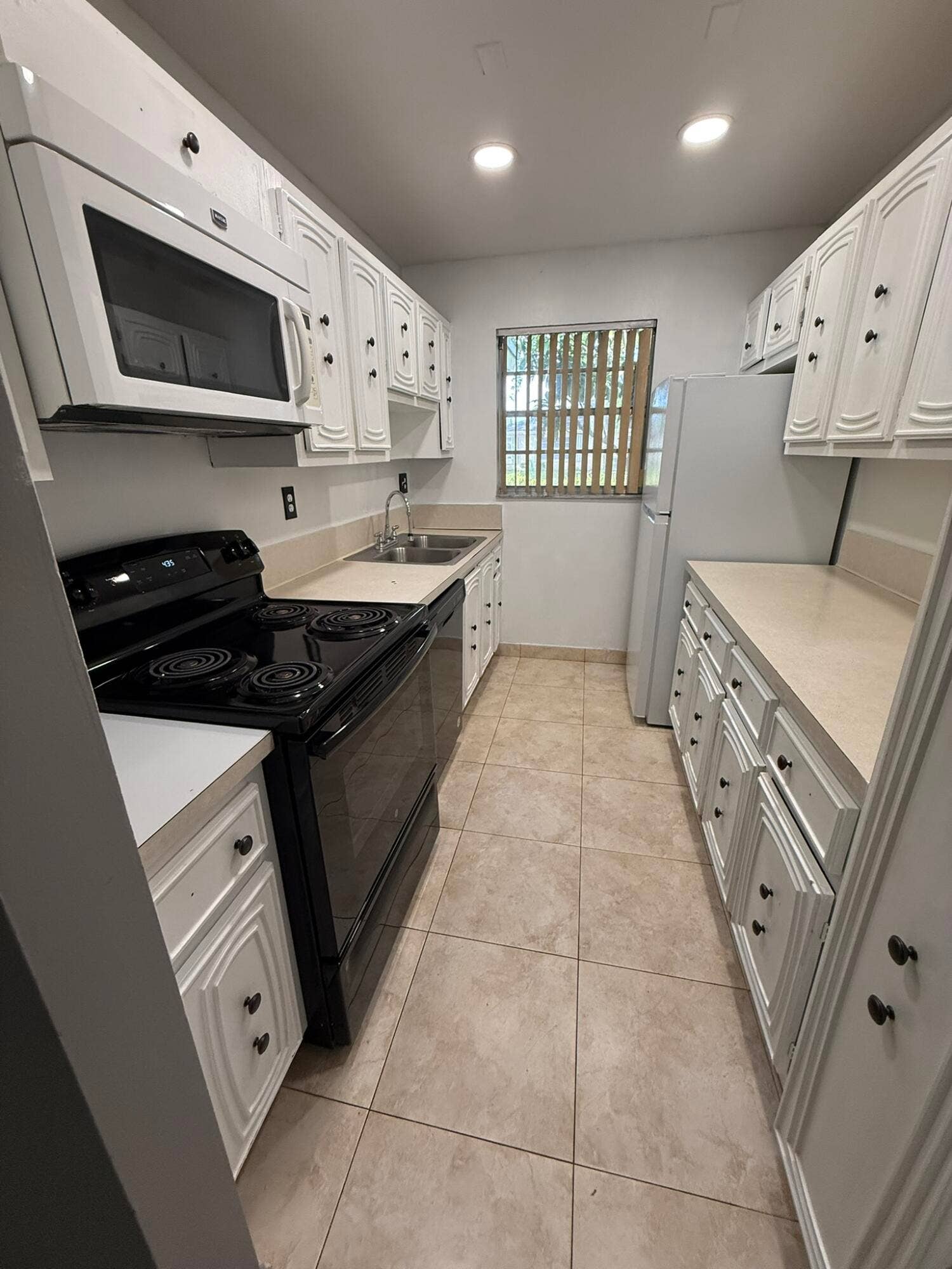 1277 High Point Boulevard W, #Unit C, Delray Beach, FL 33445 Galley Kitchen with microwave, stove, oven and dishwasher.