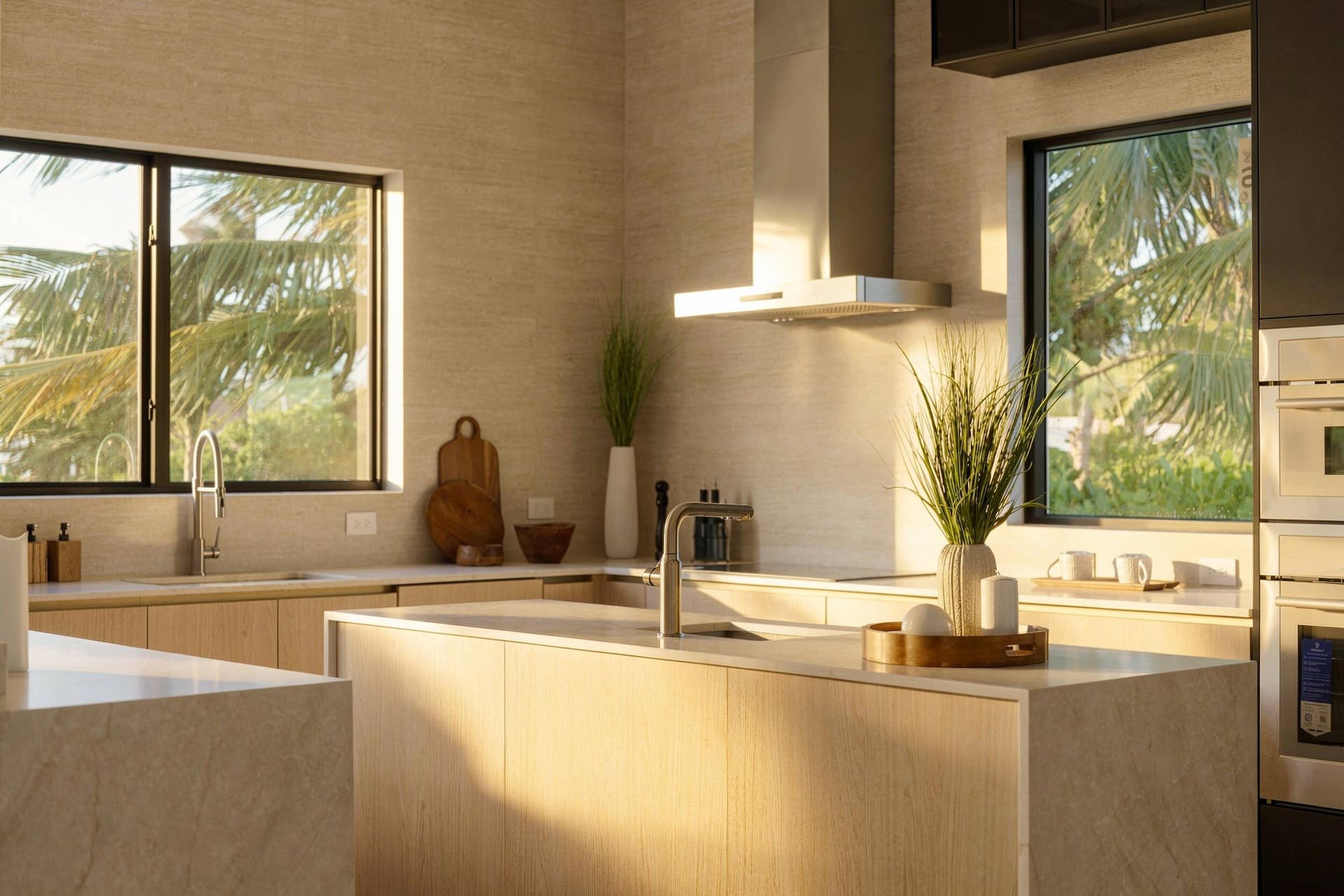 4931 NE 25TH Avenue, Lighthouse Point, FL 33064 Kitchen featuring flat-panel cabinetry, light-toned stone countertops, stainless steel wall-mounted range hood, and double-wall ovens