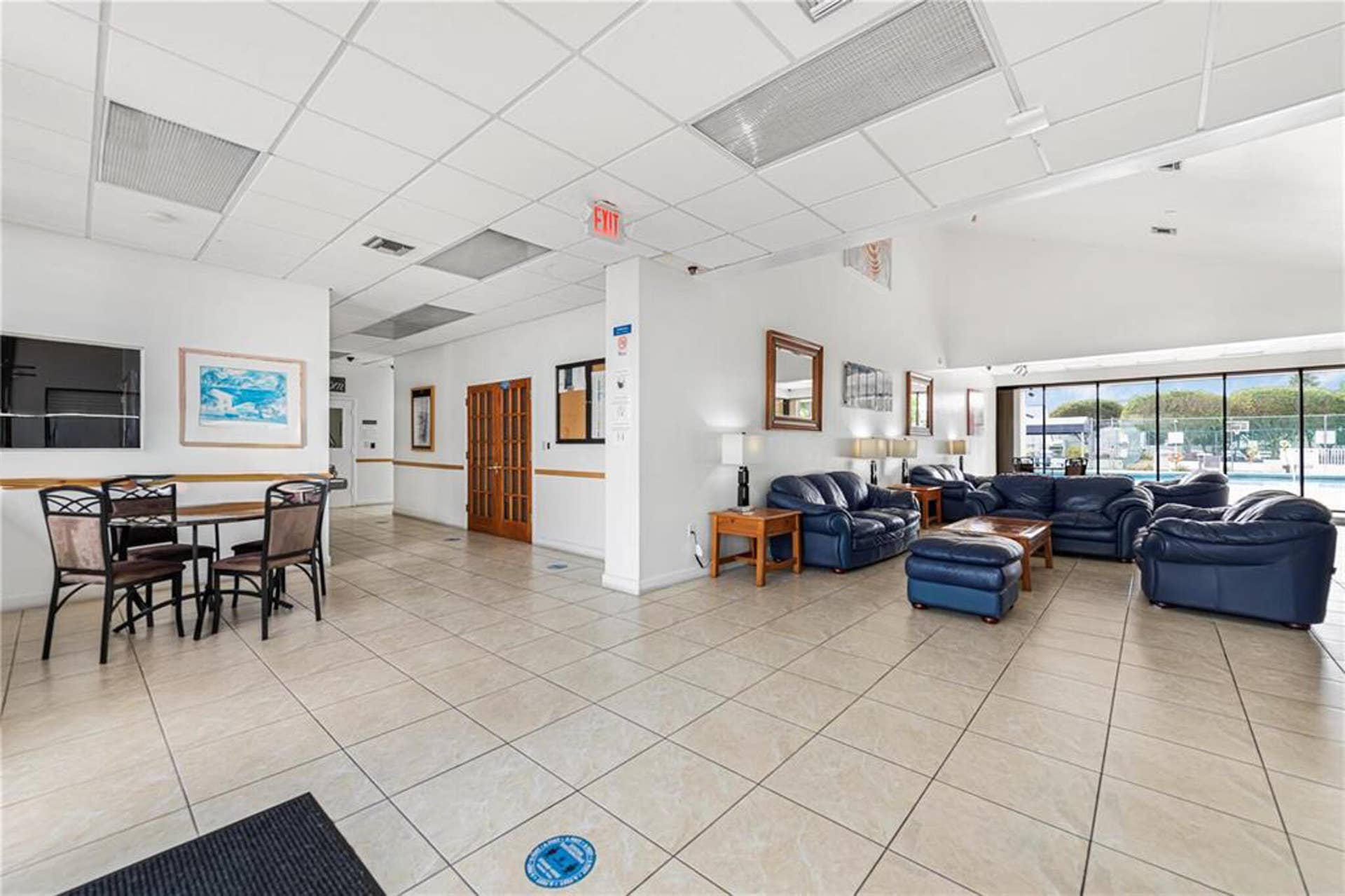 21109 NE 3RD Court, Miami, FL 33179 Open floor plan featuring large format tile flooring, vaulted ceilings, and expansive floor-to-ceiling windows
