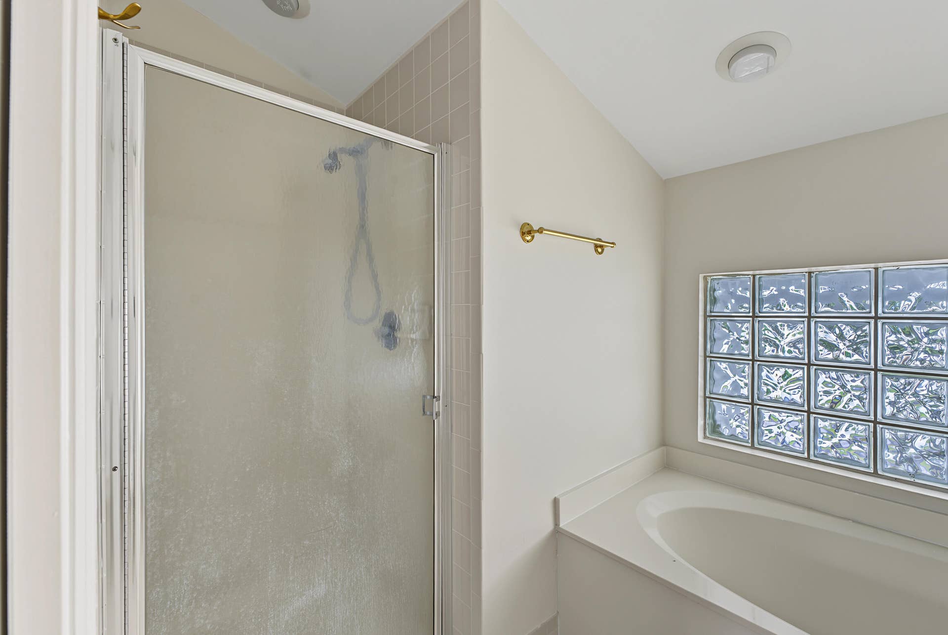 21109 NE 3RD Court, Miami, FL 33179 Shower with a glass enclosure, soaking tub, and glass block window
