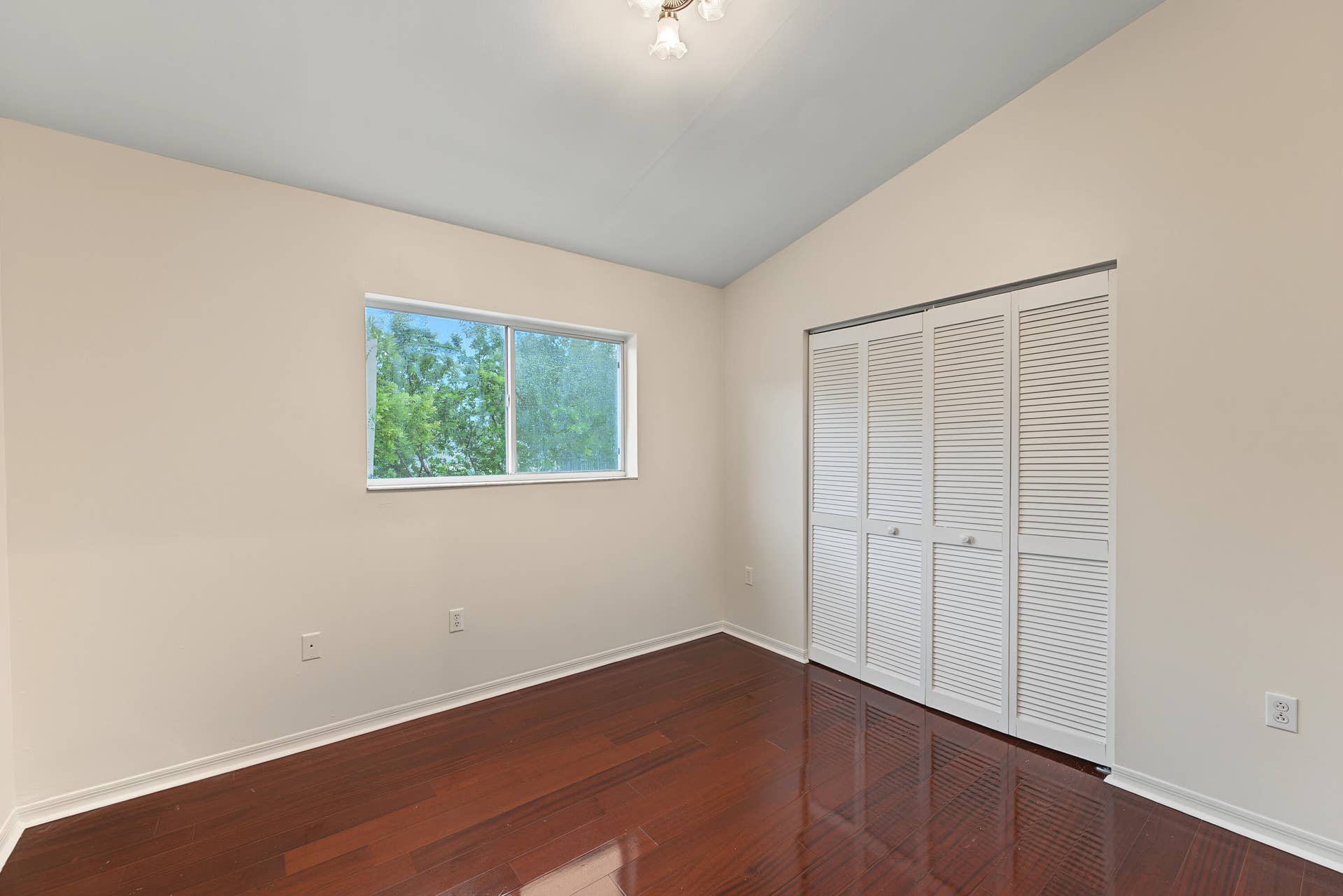 21109 NE 3RD Court, Miami, FL 33179 Vaulted ceilings, wood-finish flooring, and white louvered-style closet doors