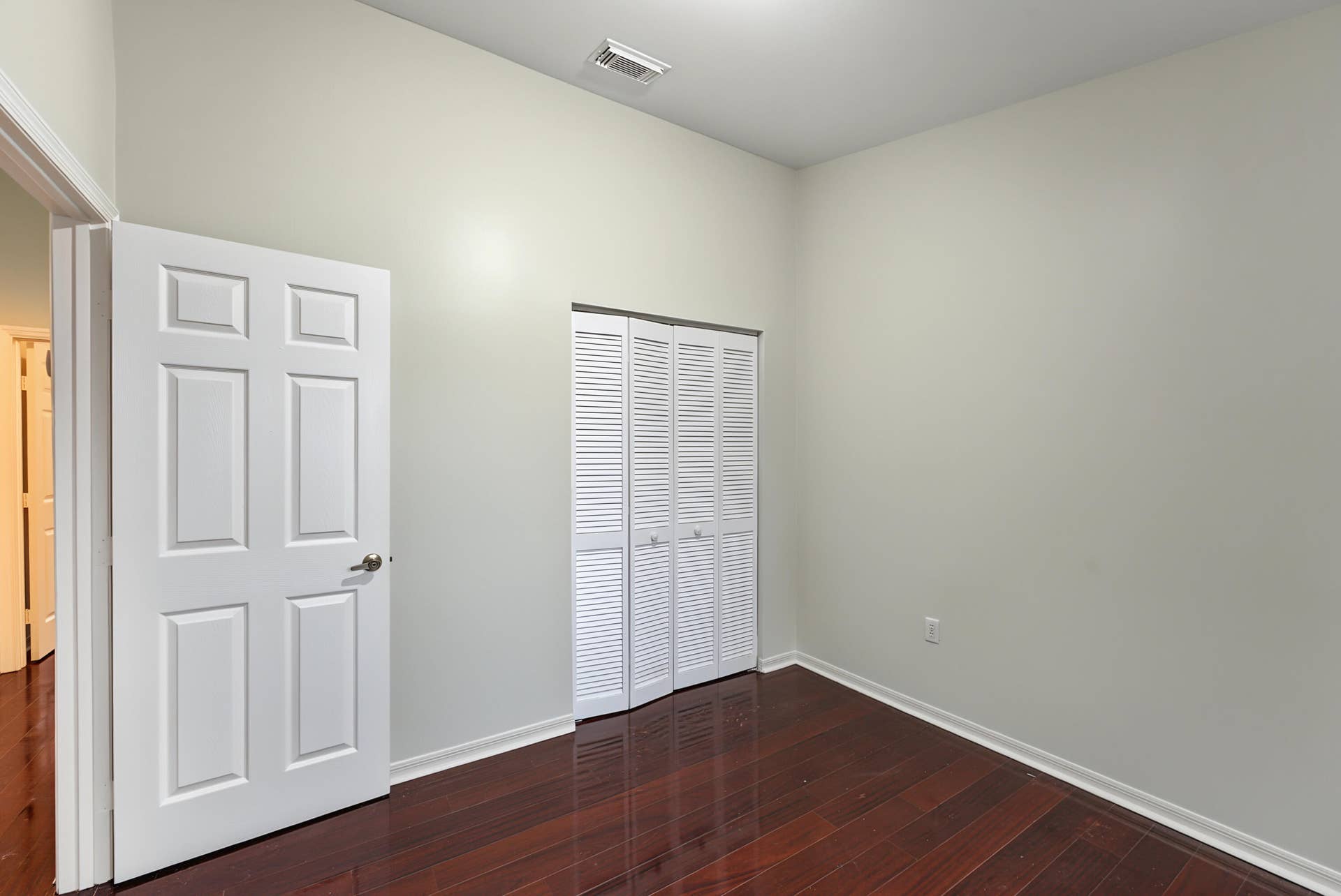 21109 NE 3RD Court, Miami, FL 33179 High ceilings, wood-finish flooring, and white louvered bifold closet doors