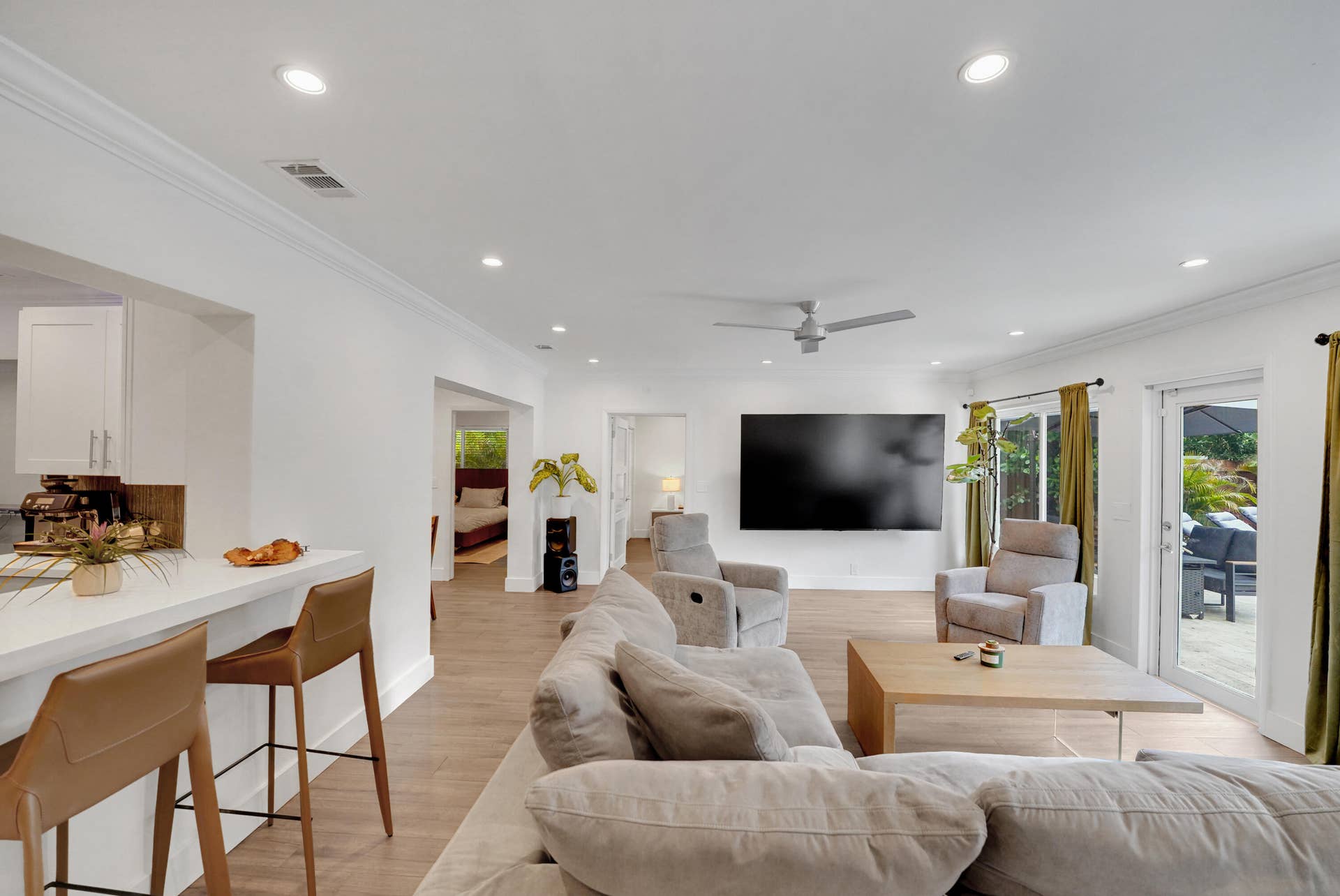 380 NW 35TH Court, Oakland Park, FL 33309 Open-concept living space featuring recessed lighting, a modern ceiling fan, and sliding glass doors to the exterior