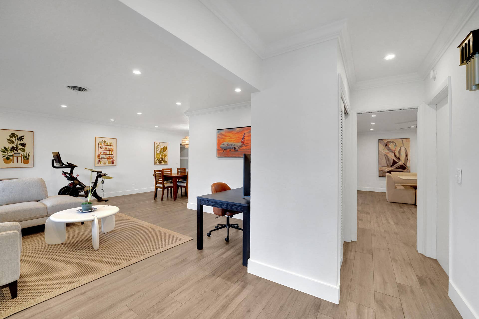 380 NW 35TH Court, Oakland Park, FL 33309 Open-concept interior featuring wood-finish flooring, recessed lighting, and crown molding