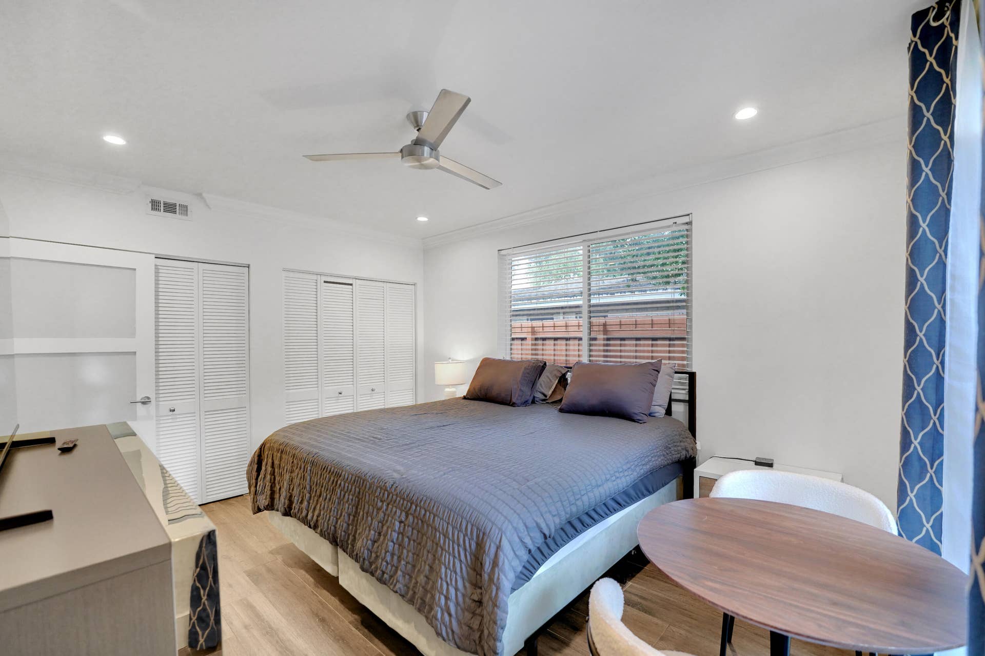 380 NW 35TH Court, Oakland Park, FL 33309 Bedroom featuring wood-finish flooring, recessed lighting, a modern ceiling fan, and louvered-panel closet doors