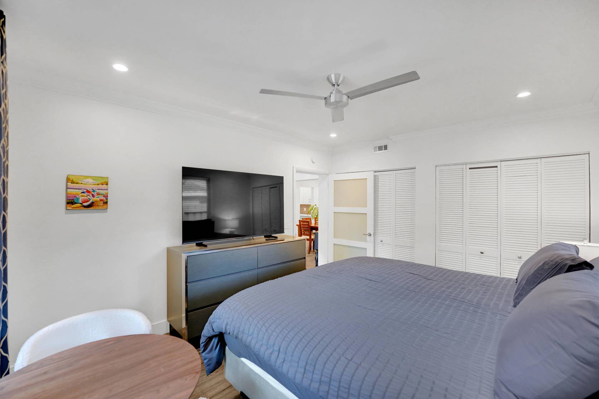 380 NW 35TH Court, Oakland Park, FL 33309 Interior space featuring recessed lighting, a satin-finish metal ceiling fan, louvered closet doors, and a multi-panel door with frosted glass inserts