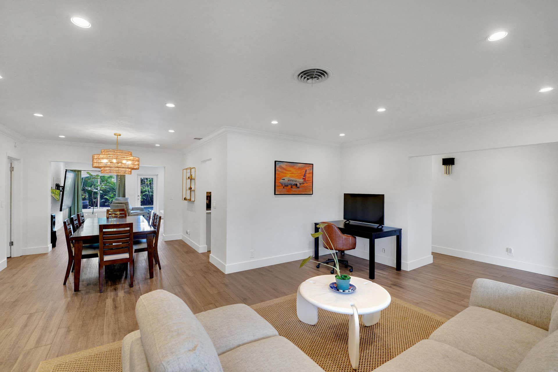 380 NW 35TH Court, Oakland Park, FL 33309 Open interior featuring wood-finish flooring, recessed lighting, and a tiered drum chandelier