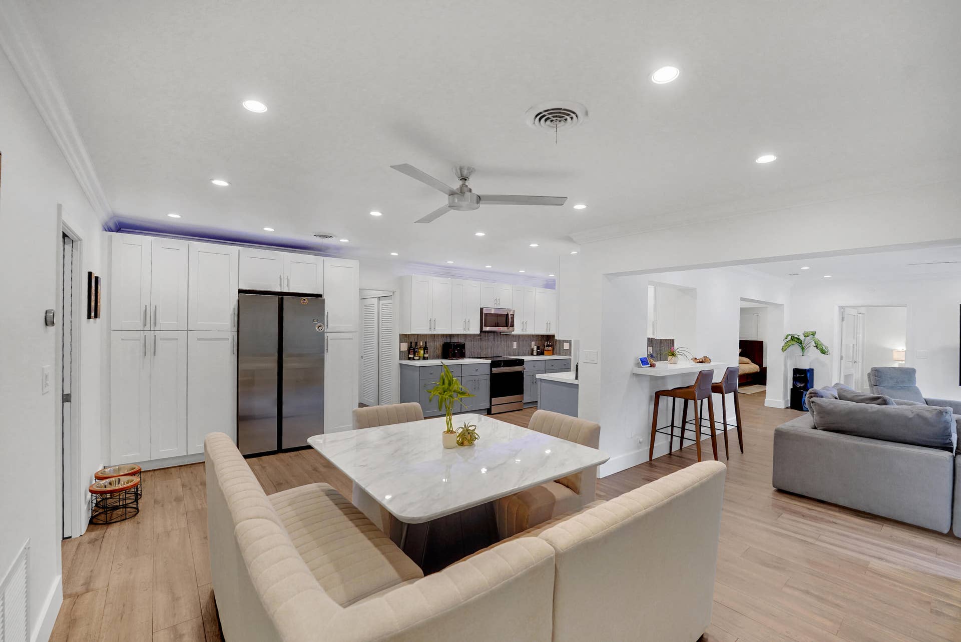 380 NW 35TH Court, Oakland Park, FL 33309 Kitchen featuring white cabinetry,recessed lighting, a breakfast bar, and stainless steel appliances