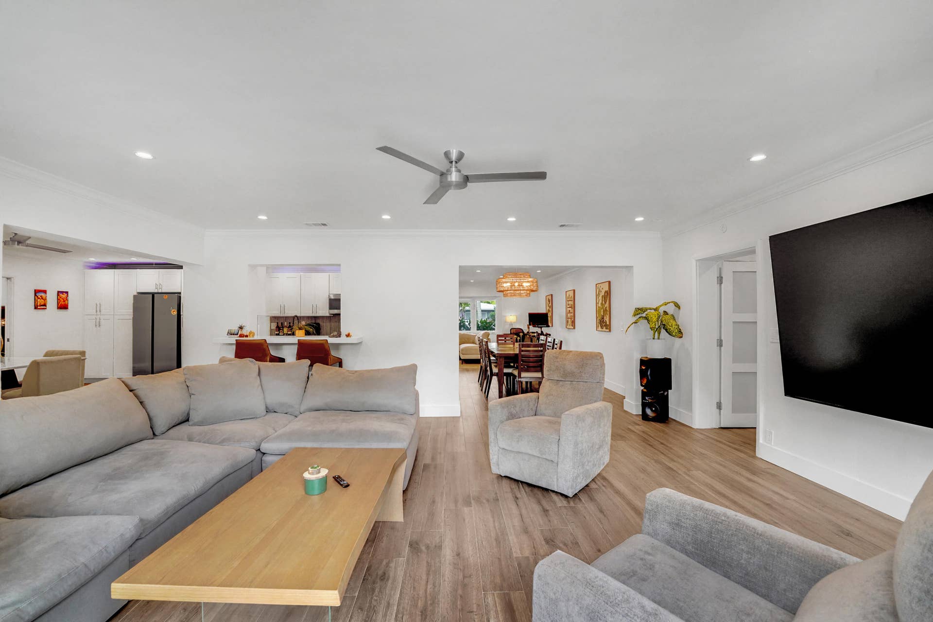380 NW 35TH Court, Oakland Park, FL 33309 Open-concept interior featuring recessed lighting, crown molding, and a central ceiling fan