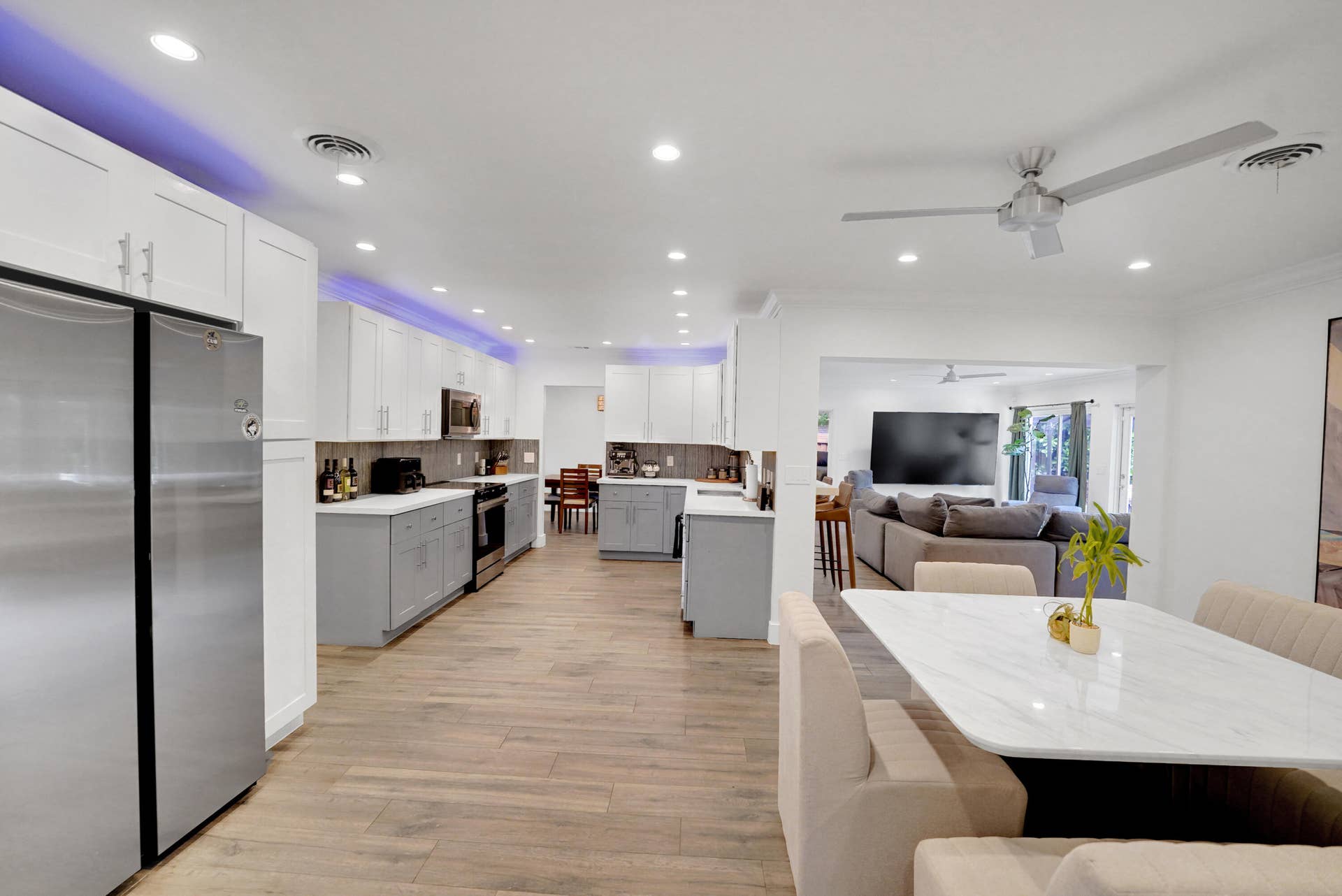 380 NW 35TH Court, Oakland Park, FL 33309 Kitchen featuring two-tone shaker cabinetry, stainless steel appliances, recessed lighting, and cove accent lighting