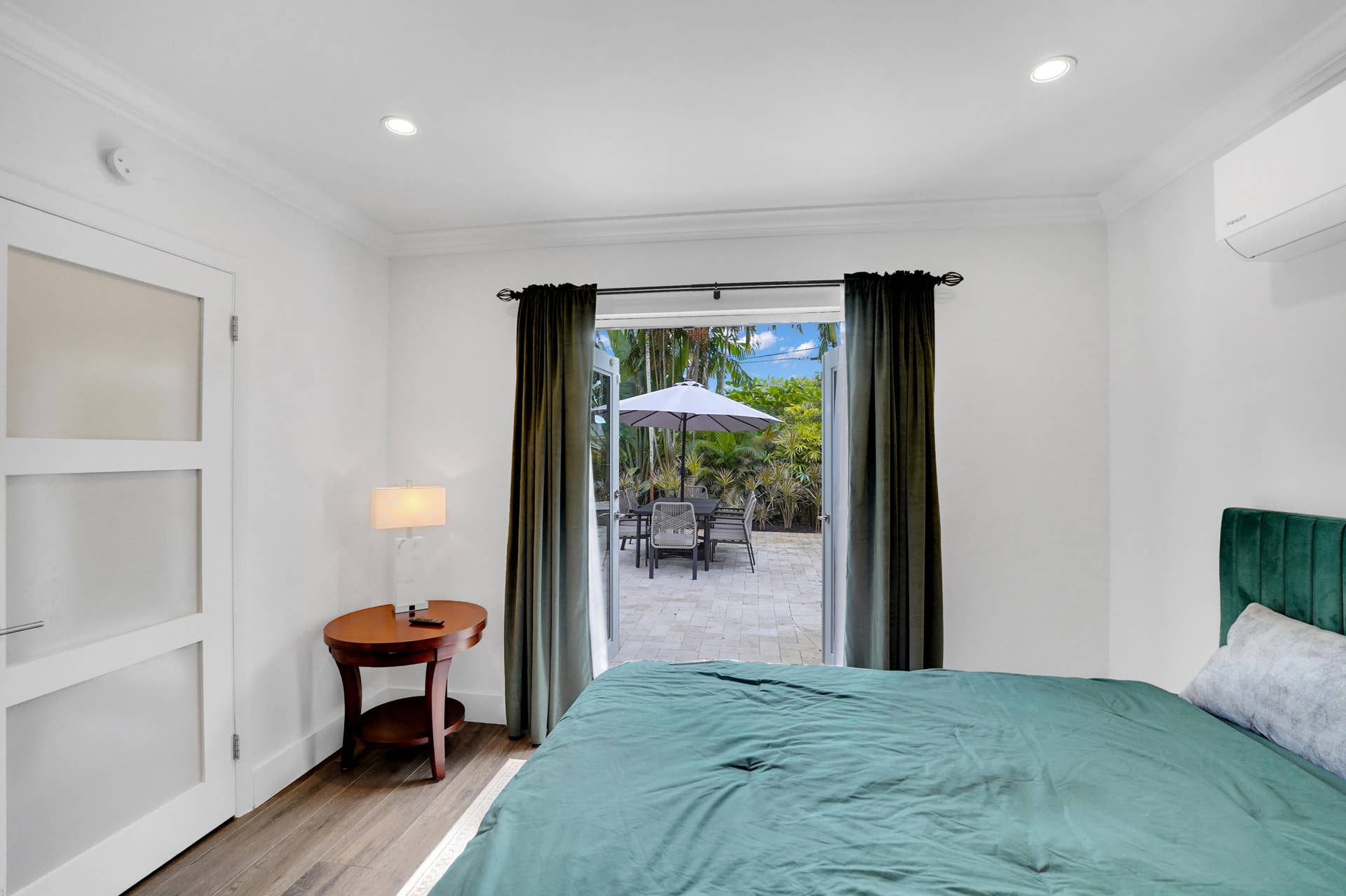 380 NW 35TH Court, Oakland Park, FL 33309 Double French doors with frosted glass accents, recessed lighting, wall-mounted climate control unit.
