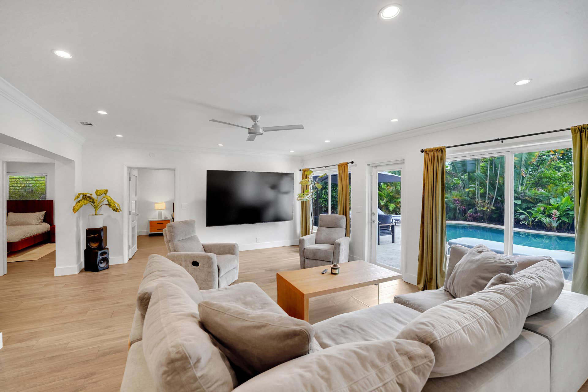 380 NW 35TH Court, Oakland Park, FL 33309 Living area with recessed lighting, crown molding, a ceiling fan, and sliding glass doors providing outdoor access