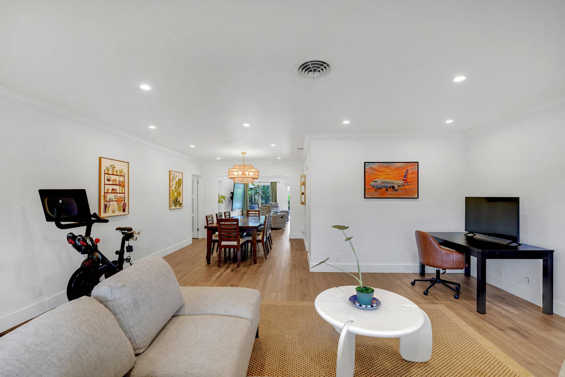 380 NW 35TH Court, Oakland Park, FL 33309 Open-concept interior featuring recessed lighting, wood-finish flooring, and a decorative pendant light fixture