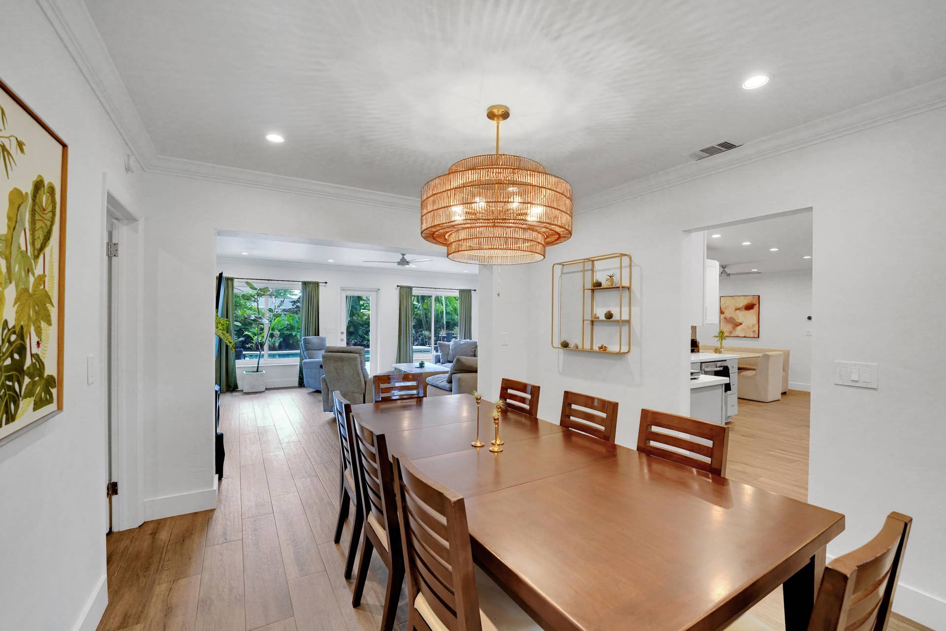 380 NW 35TH Court, Oakland Park, FL 33309 Dining area featuring wood-finish flooring, a tiered woven pendant light fixture, crown molding, and recessed lighting