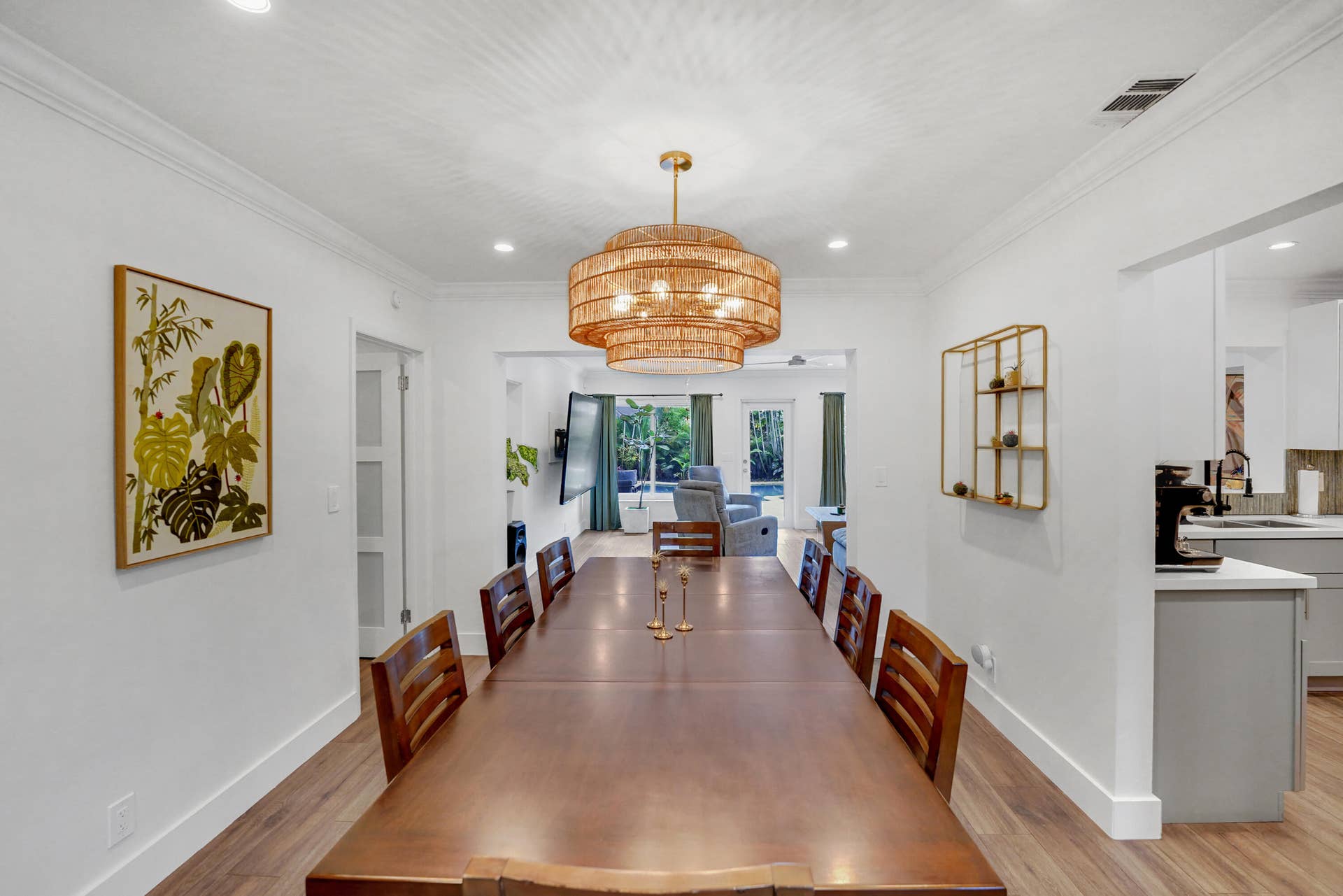 380 NW 35TH Court, Oakland Park, FL 33309 Dining space featuring wood-finish flooring, crown molding, recessed lighting, and a multi-tiered woven pendant fixture