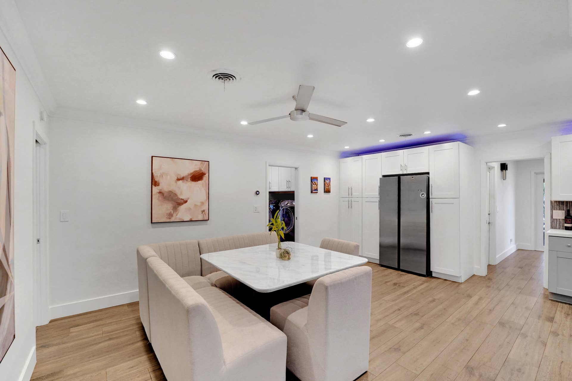 380 NW 35TH Court, Oakland Park, FL 33309 Wood-finish flooring, recessed lighting, ceiling fan, and floor-to-ceiling white cabinetry with a stainless steel side-by-side refrigerator