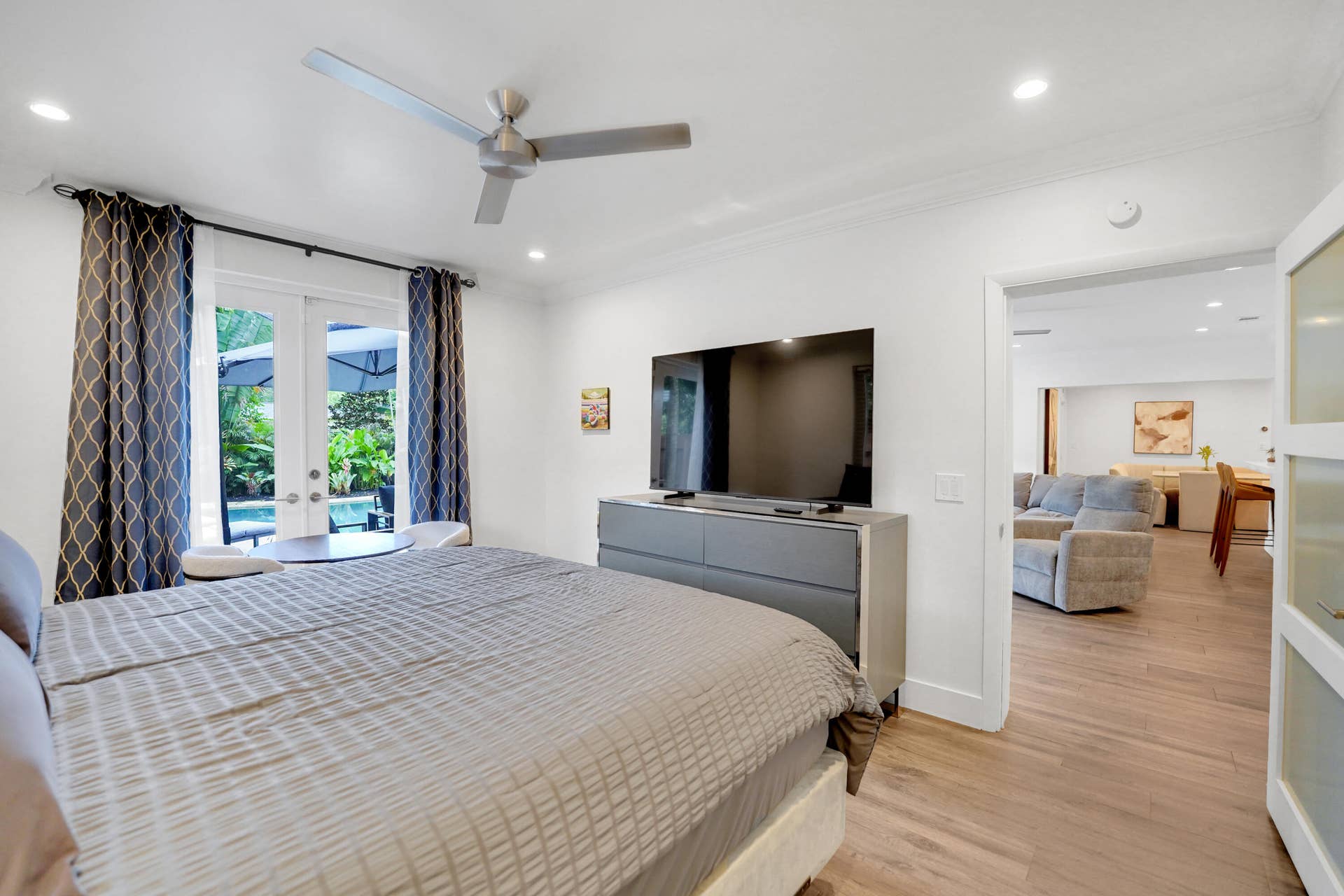 380 NW 35TH Court, Oakland Park, FL 33309 Interior space featuring wood-finish flooring, recessed lighting, crown molding, a ceiling fan, and French doors