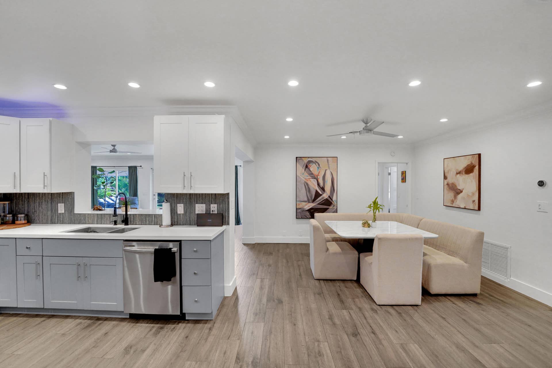 380 NW 35TH Court, Oakland Park, FL 33309 Kitchen featuring two-tone cabinetry, stainless steel dishwasher, recessed lighting, and a neutral tile backsplash