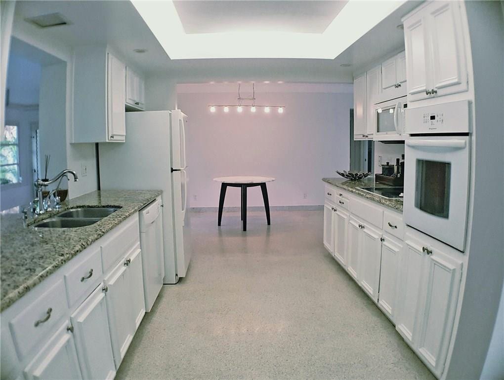 Fort Lauderdale, FL 33308 Spacious galley kitchen featuring granite counters, double stainless sink, filtered water at the sink wall oven and electric cooktop.
