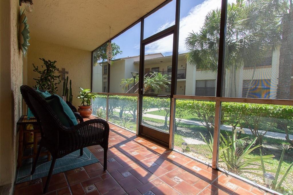 Screened porch with mexican tile flooring with storage closet