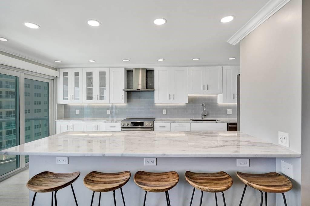 The quartz eat in kitchen counter easily seats 5 people. The kitchen sliding doors are brand new high impact glass. The sliding doors lead out to the balcony.