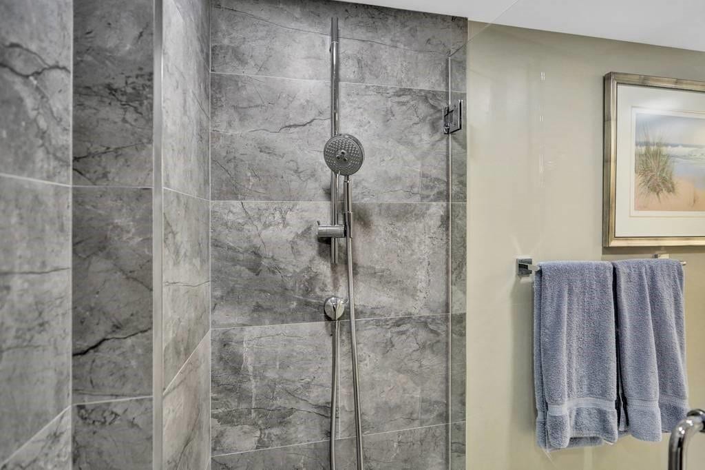 The second bathroom shower was also enlarged, and is beautifully tiled, with a frameless glass door.