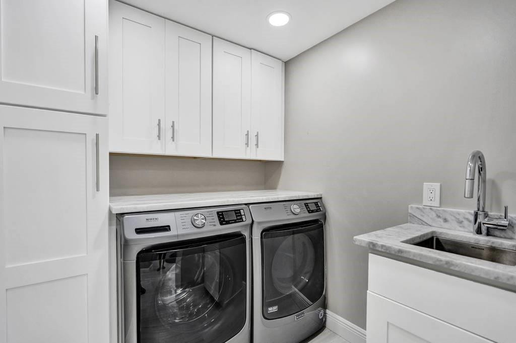 The air conditioned laundry room has plenty of cabinet space and a sink. The full size washer and dryer are Maytag. The sink faucet is Hansgrohe. This laundry room was custom designed by the owner.