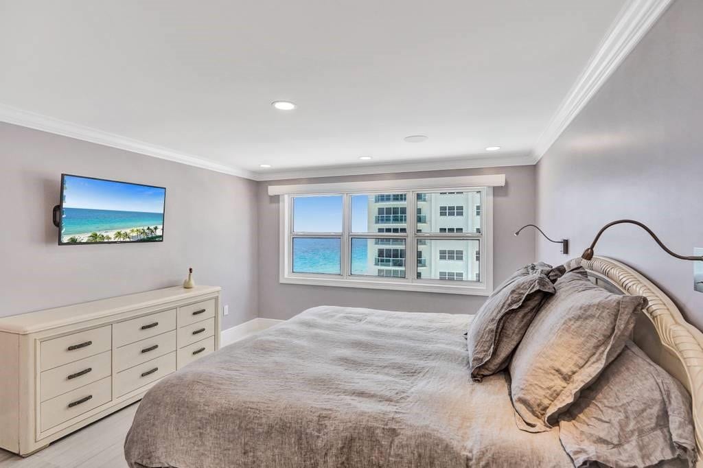 The master bedroom has a view of the ocean from the bed.