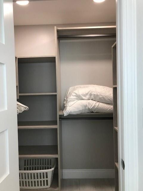This tricked out walk in closet has plenty of storage, recessed lighting and air conditioning.