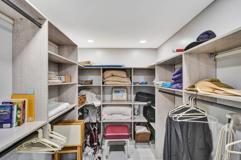 The master bedroom walk in closet has recessed lighting and is air conditioned.