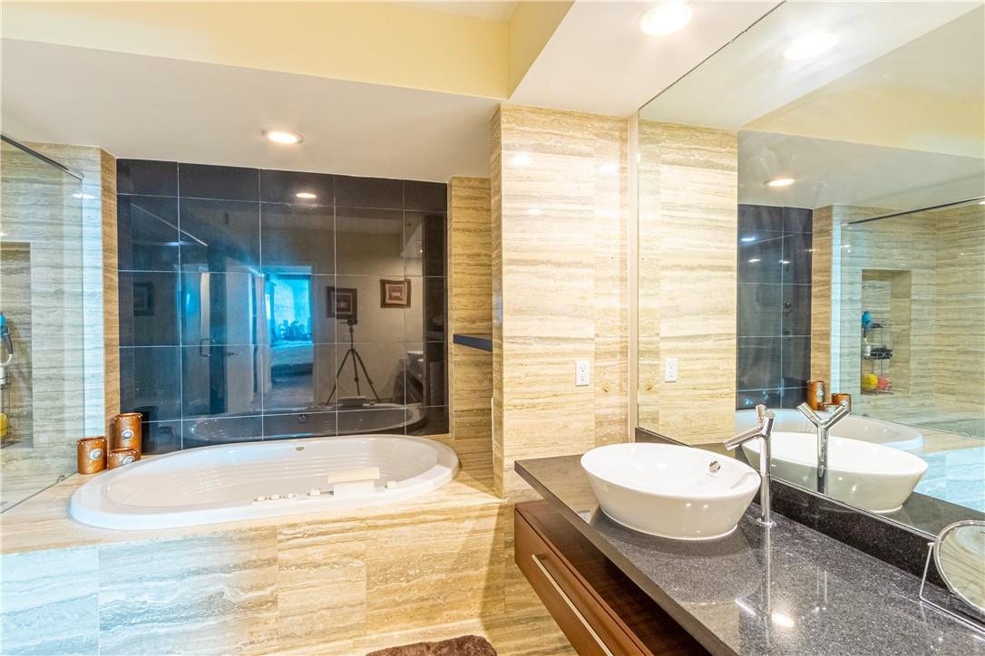 Double sink vanity with bah tub.