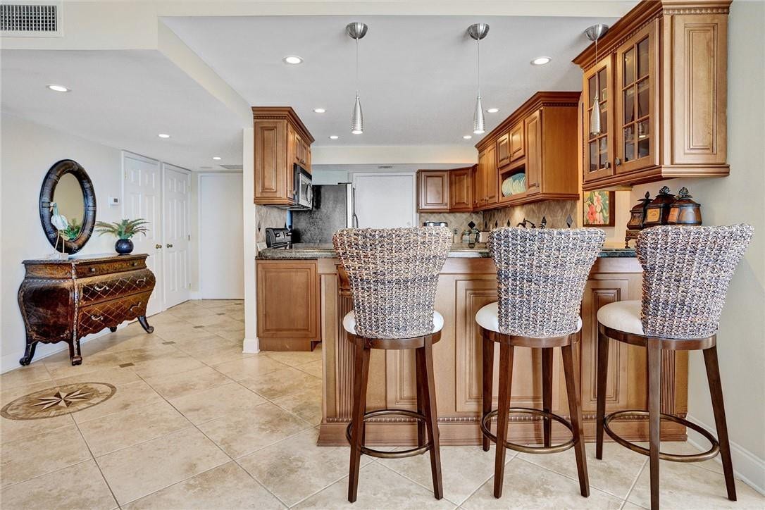 The kitchen has a bar area for seating.