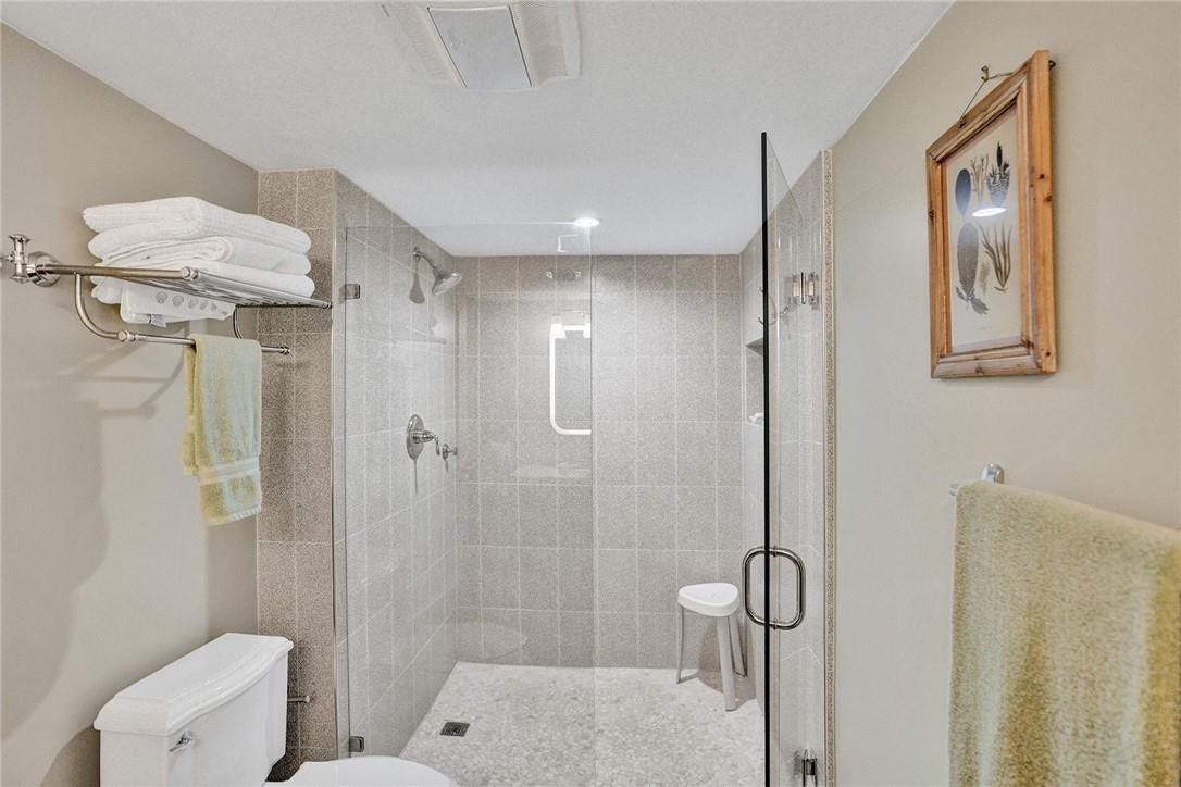 The primary bathroom has a frameless glass shower stall.