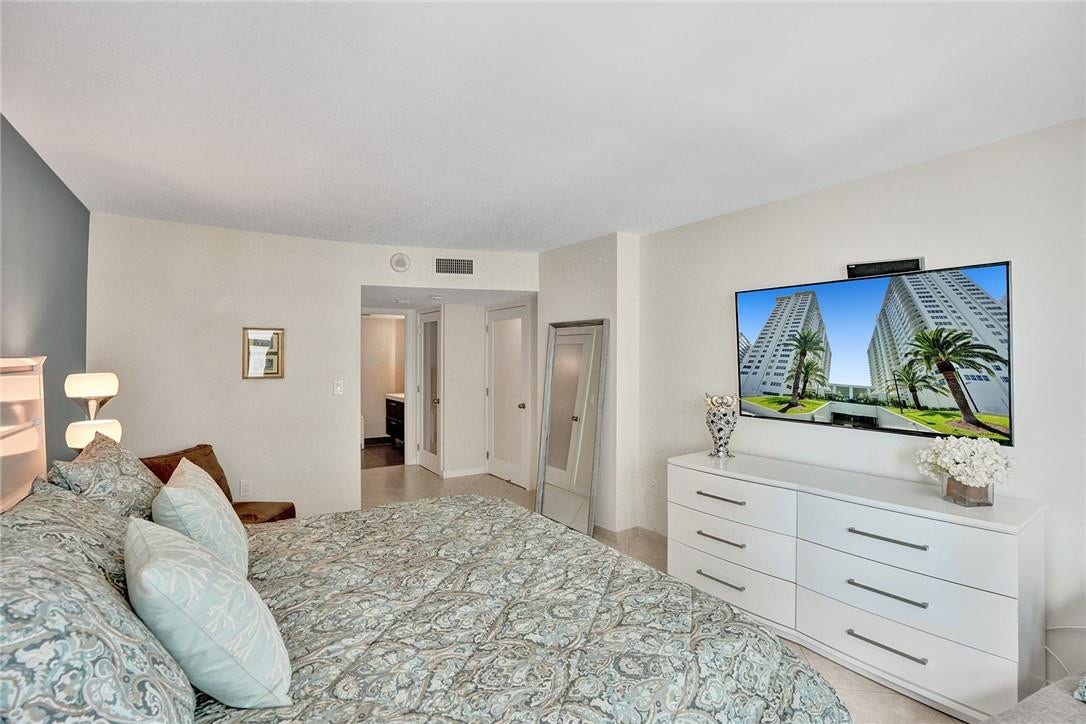The doorway leads into the primary bathroom. The walk in closet is to the left and the linen closet is to the right.